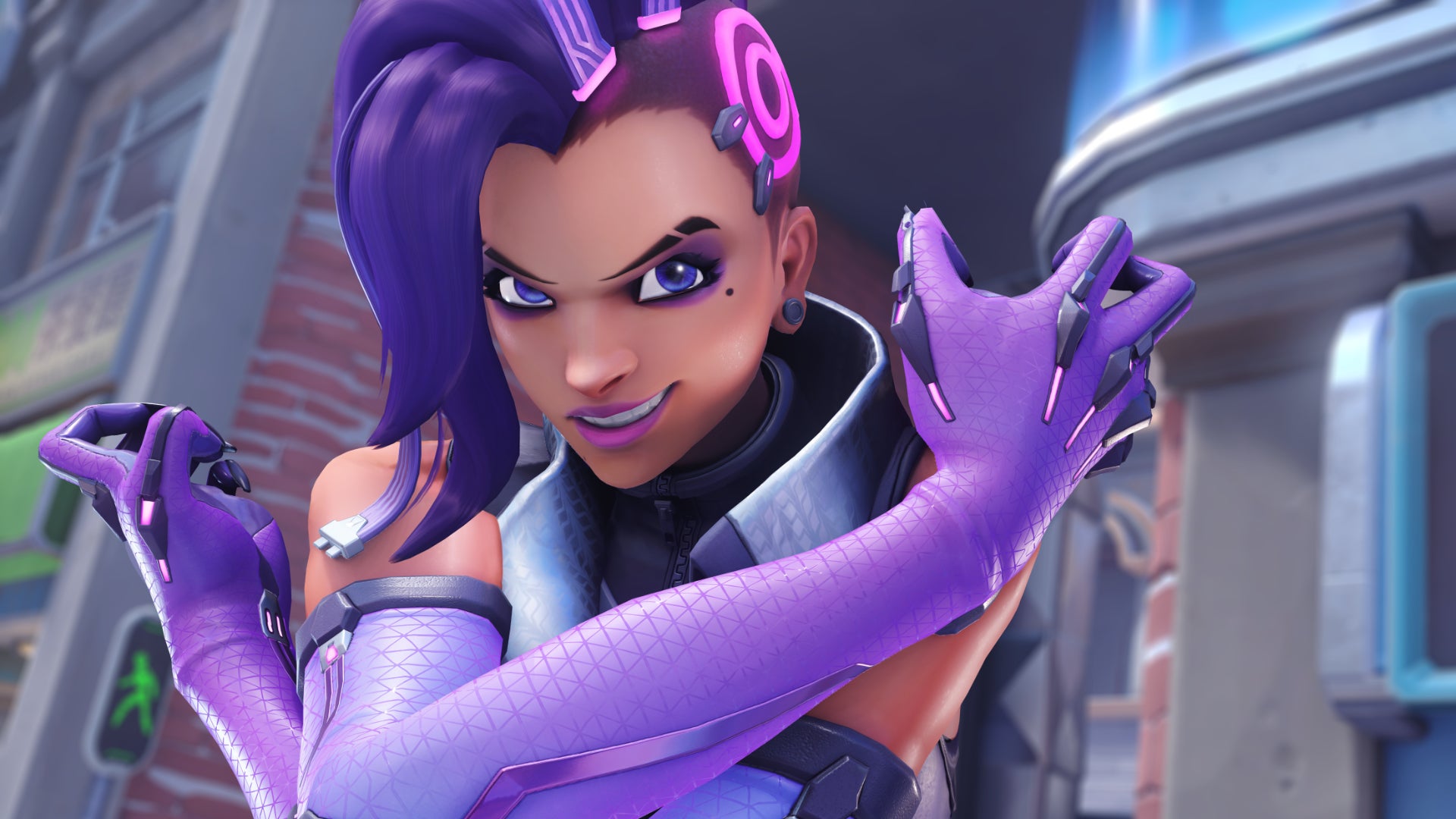 A close up of Sombra, a hero in Overwatch 2, smiling at the camera with her arms crossed and grabbing her shoulders.