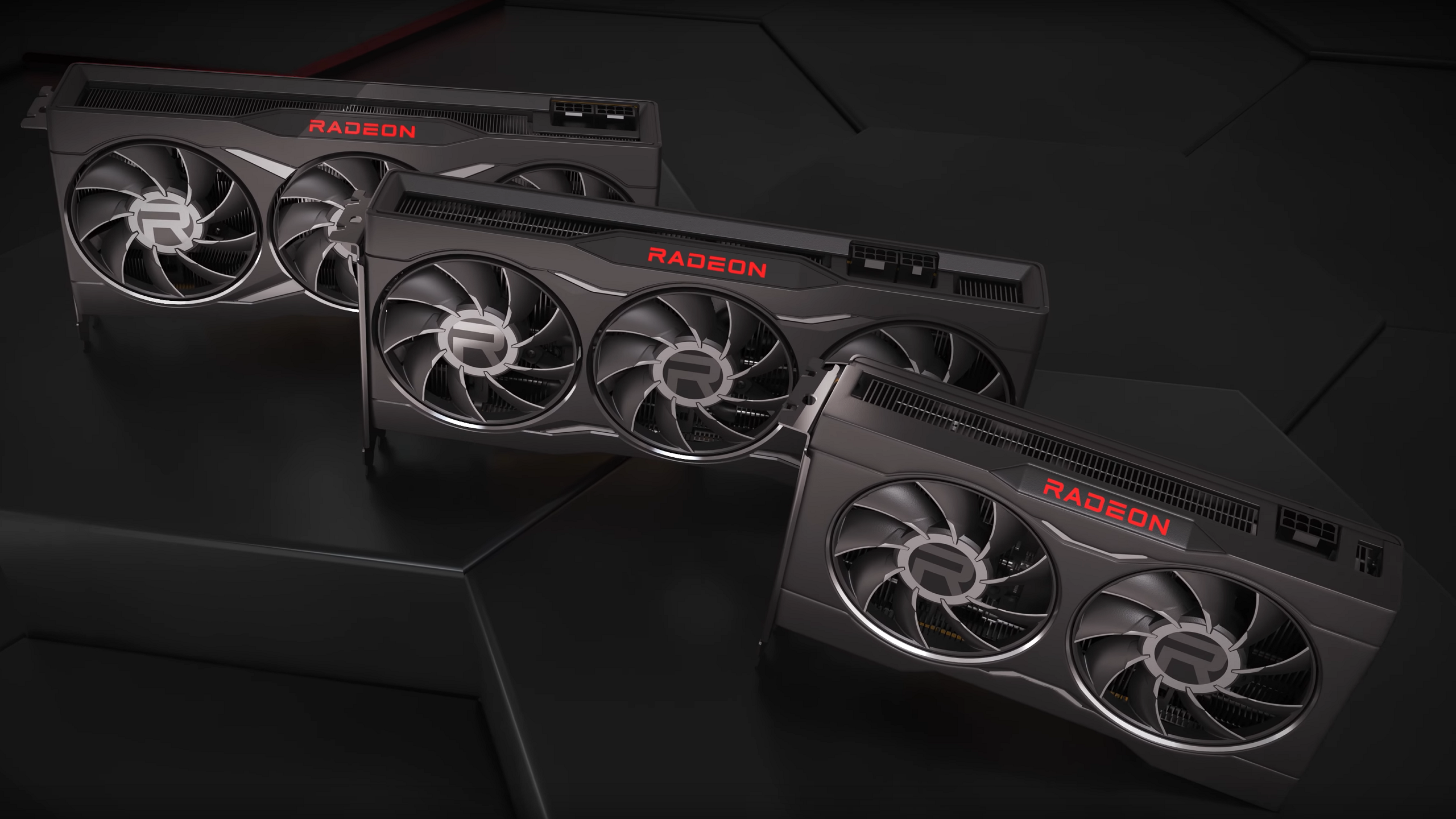 Renders of the AMD Radeon RX 6650 XT, Radeon RX 6750 XT and Radeon RX 6950 XT graphics cards on a black platform.