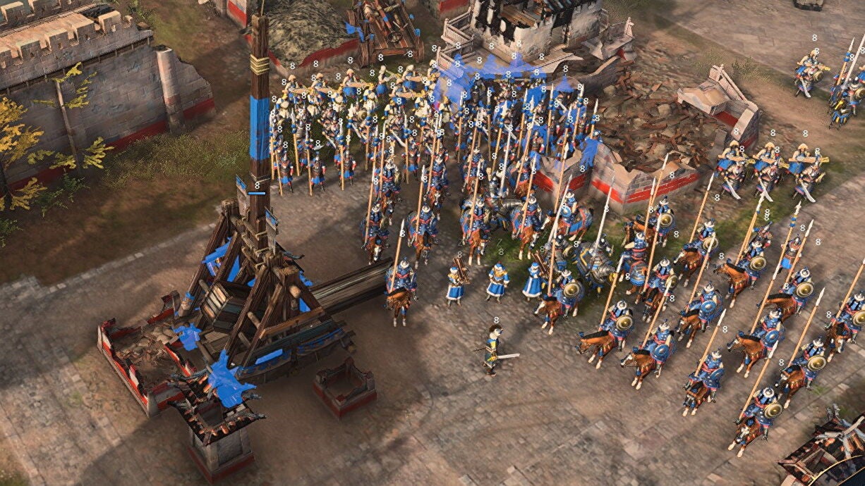 Many spearmen gather behind a trebuchet