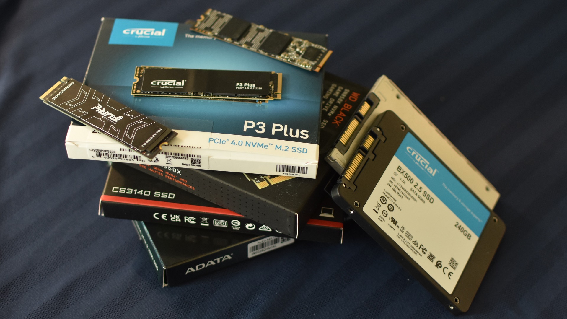 A stack of various NVMe and 2.5in SSDs.