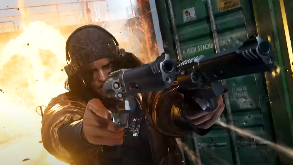 A screenshot from Call Of Duty Modern Warfare 2's Shipment map trailer showing a soldier pointing two revolvers while an explosion goes off behind them