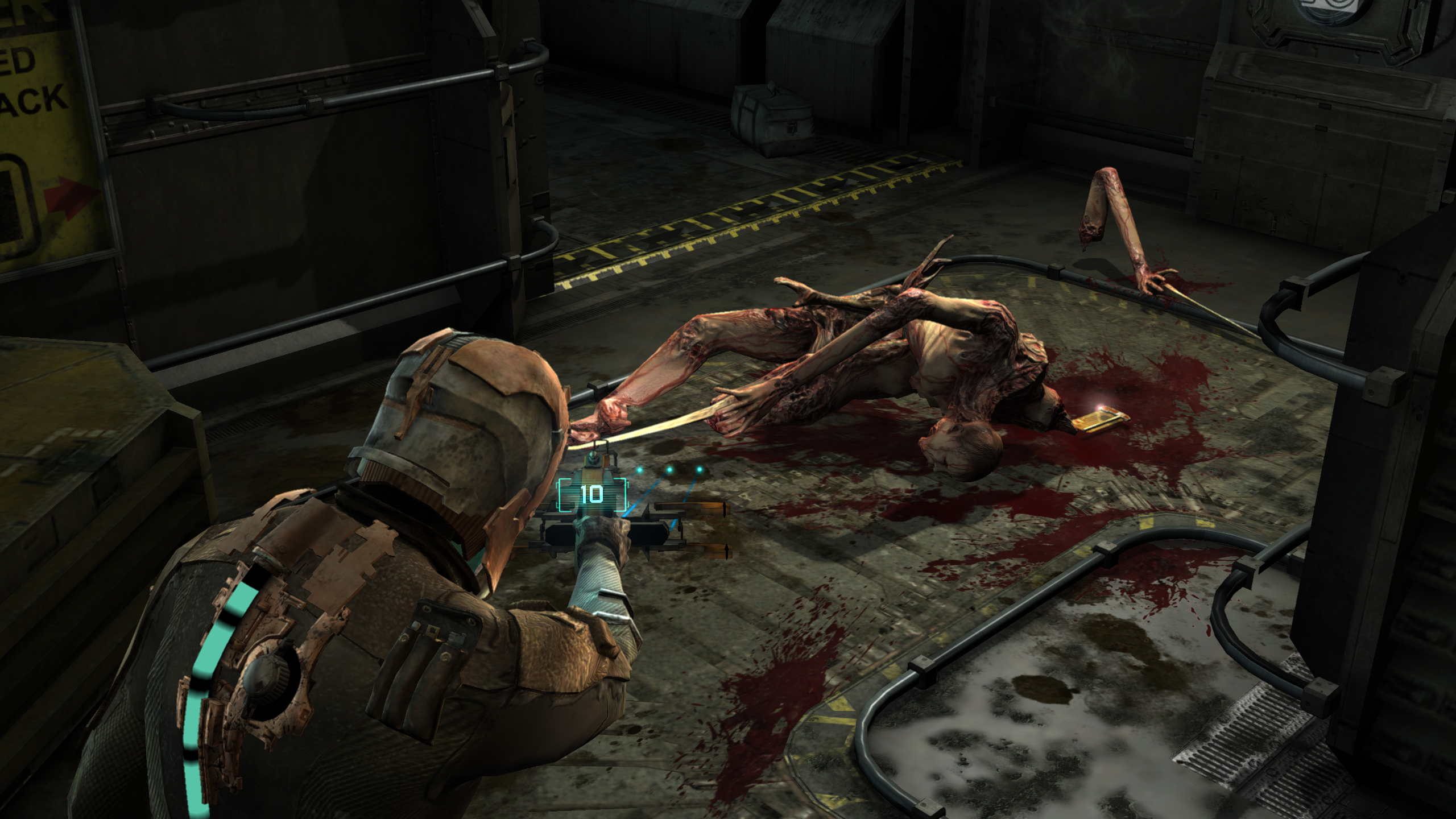 A dead Slasher necromorph lies on the ground in Dead Space.