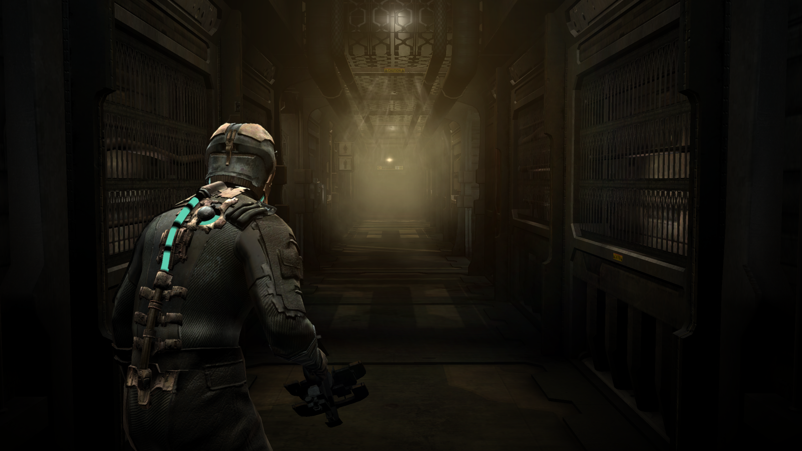 Isaac enters a forebodingly long, seeming empty hallway in Dead Space.