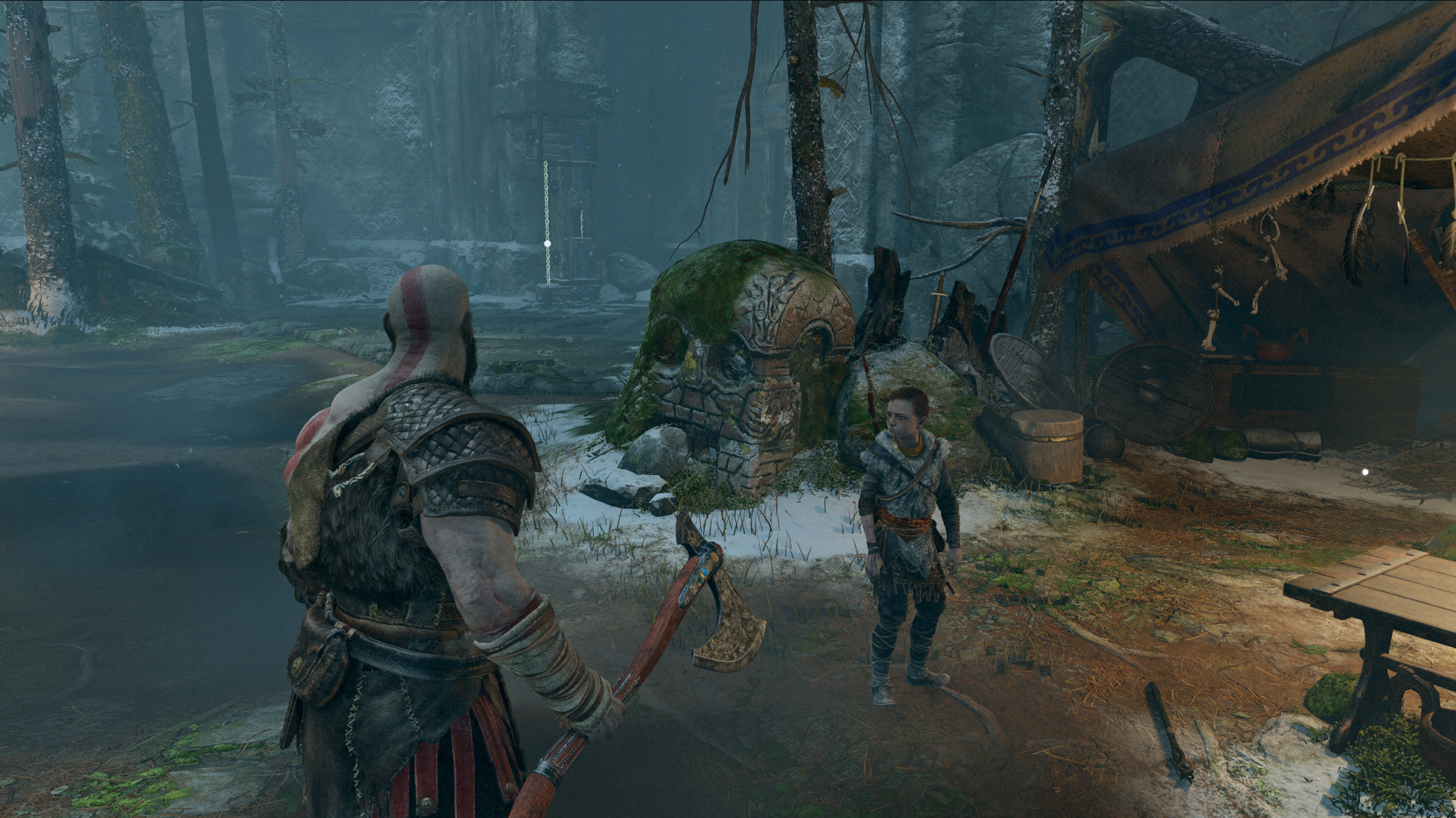 Kratos stands in front of a skull-shaped stone in God of War. Shows AMD FSR 2.0 upscaling to 1440p.