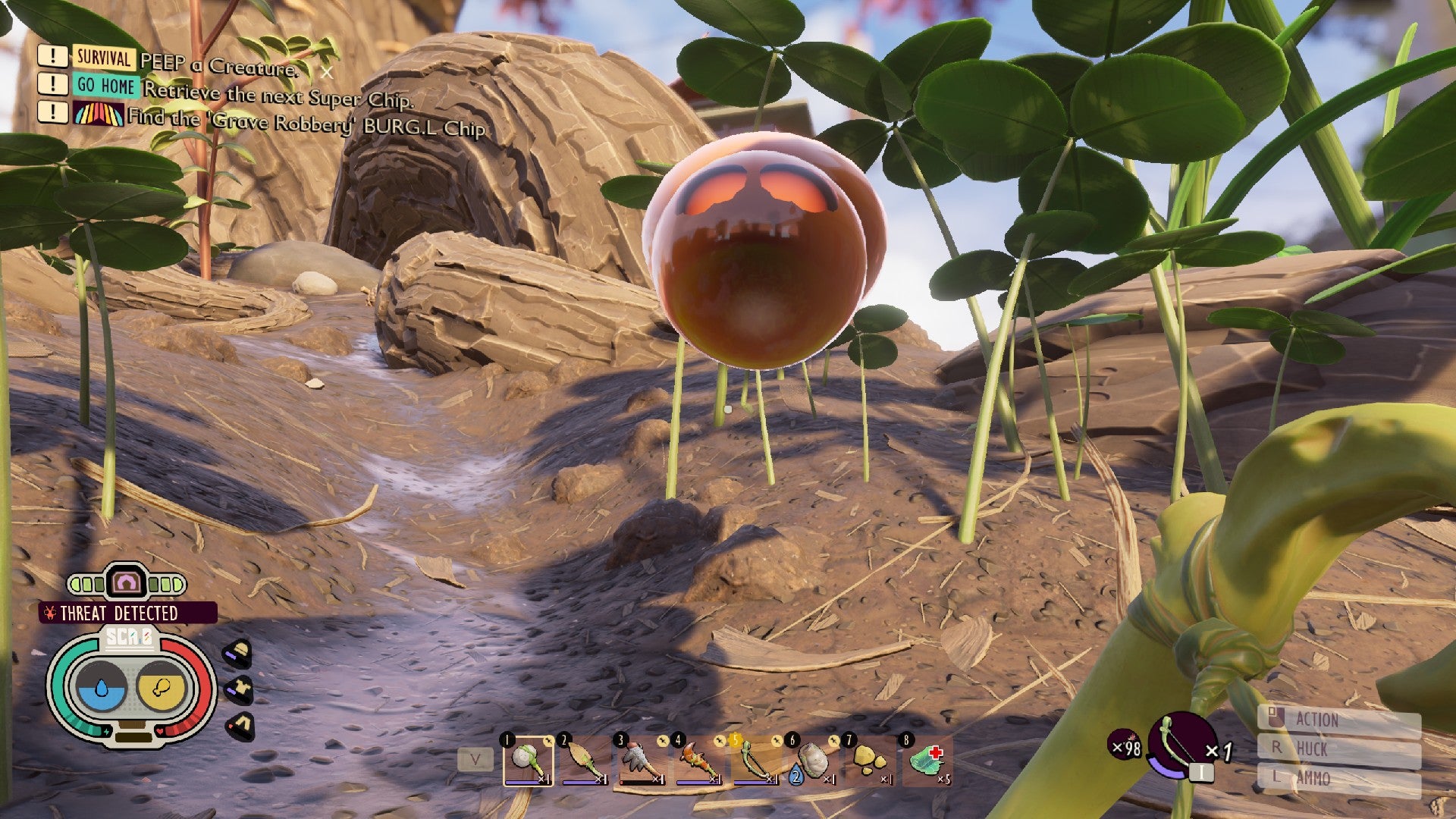 Jugador conectado a tierra que mira fijamente la mancha naranja con ojos rojos radiantes que representa una araña en modo aracnofobia.