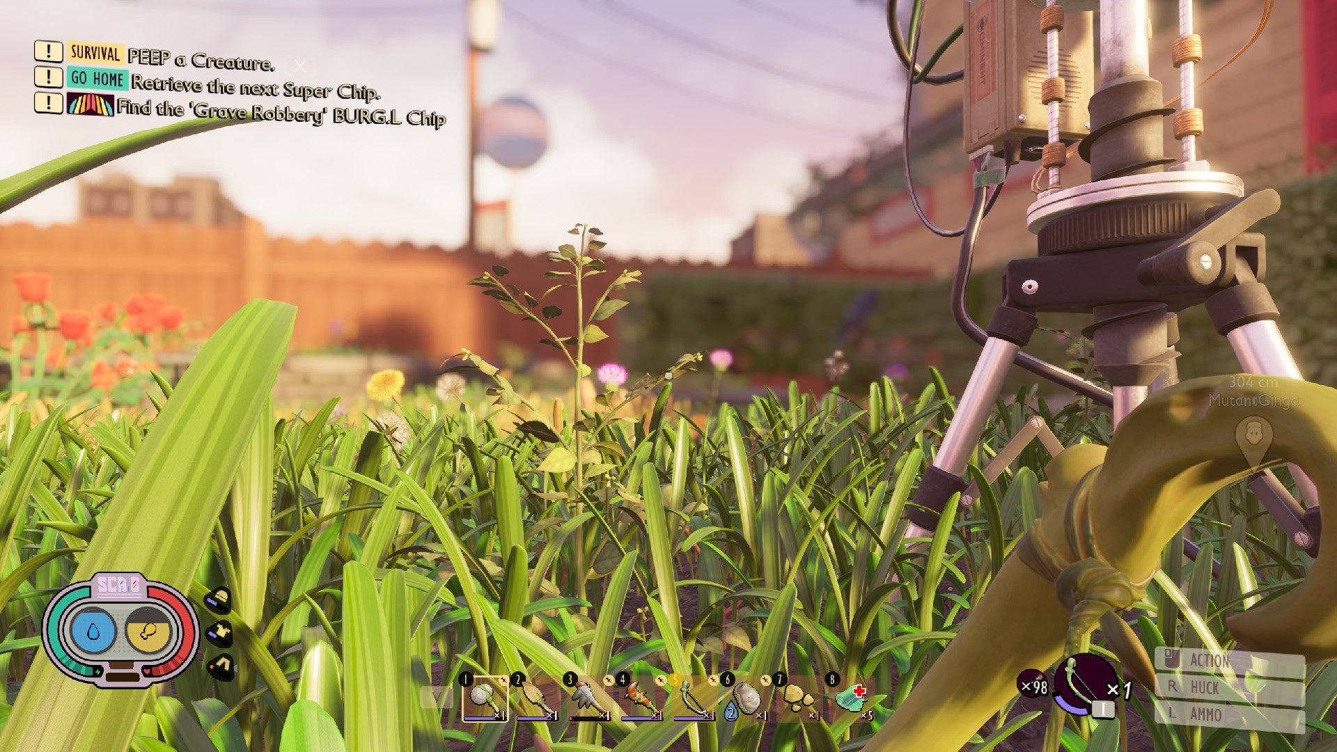 Jugador en tierra mirando por encima de las briznas de hierba, con un gran trípode científico que se cierne a la derecha.