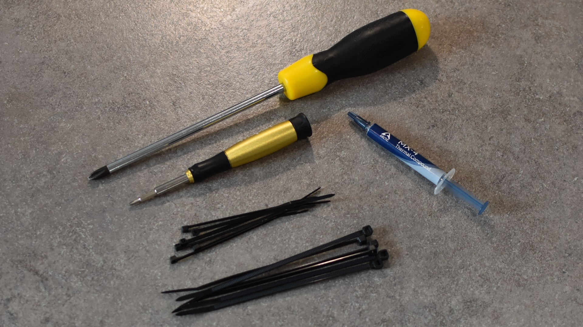 The tools you'll need to build a PC: crosshead screwdrivers, thermal paste, and cable ties.