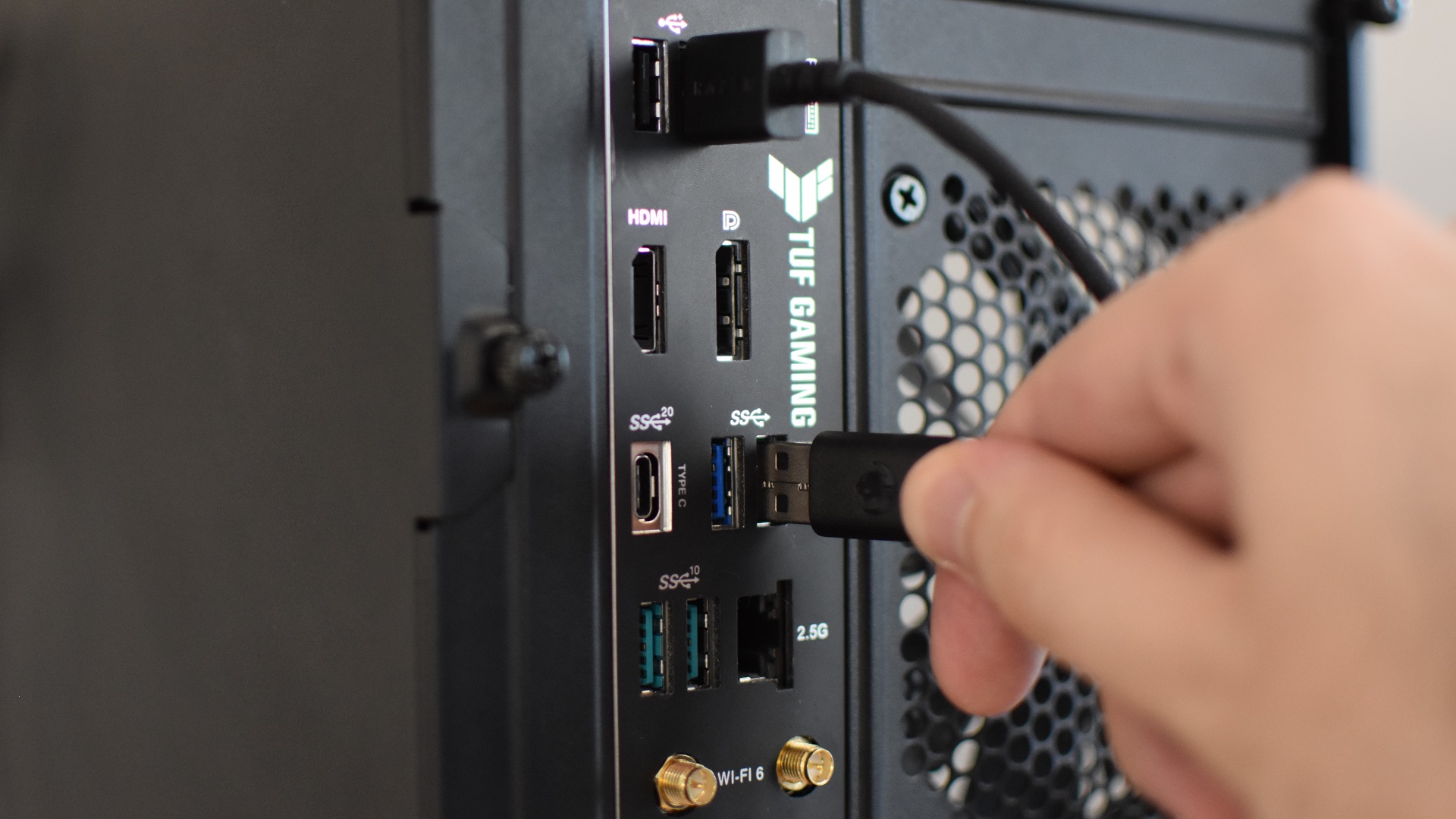 Connecting various USB peripherals, like a mouse and keyboard, to a gaming PC's rear I/O panel.