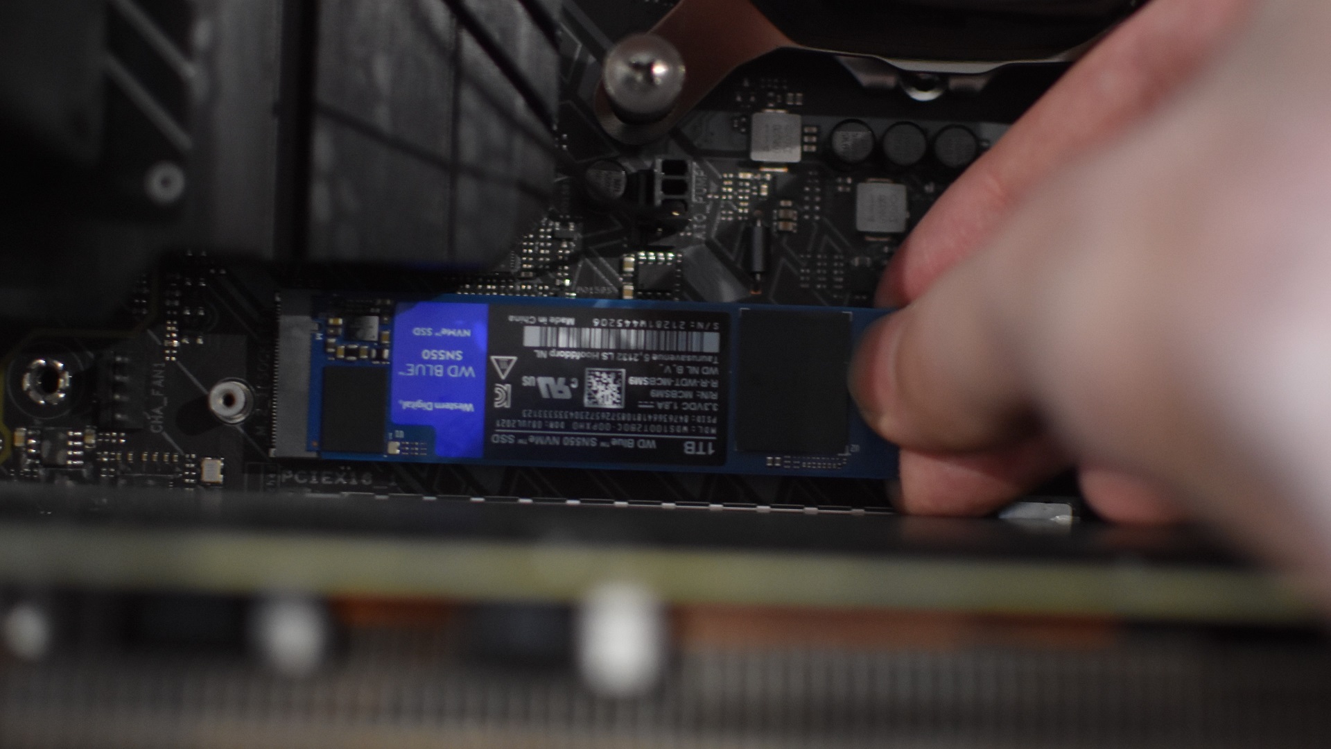 Step 2 of how to install an NVMe SSD: Insert the SSD sideways into the M.2 slot.