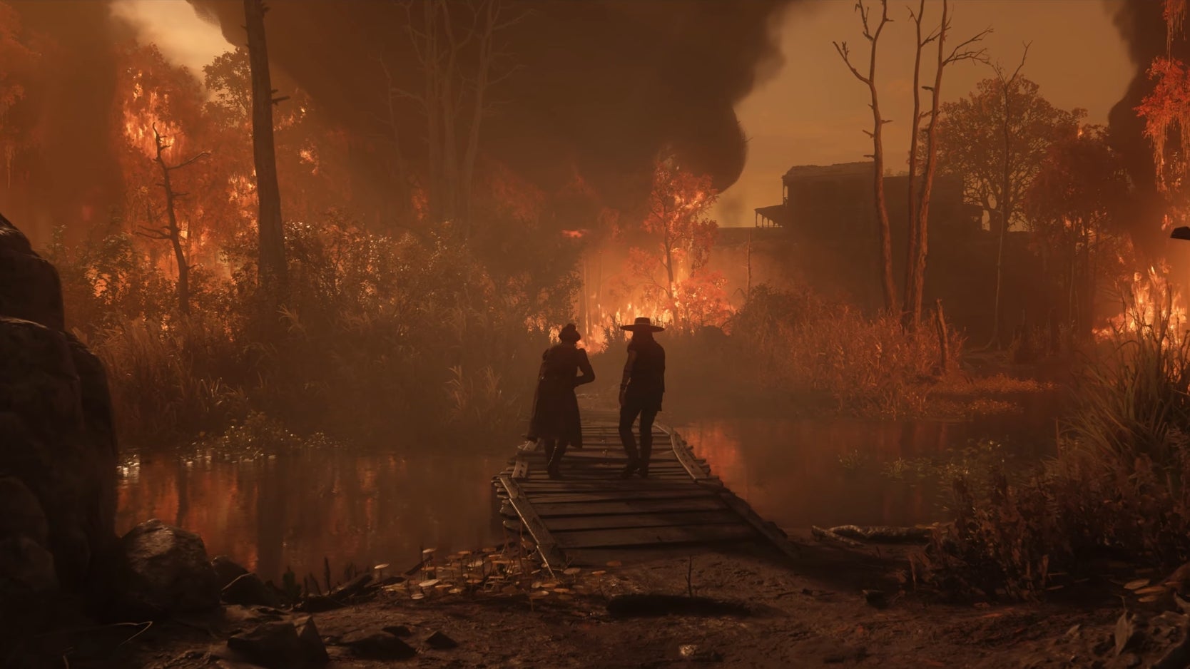Two cowboys walk along a bridge in a swamp that is on fire