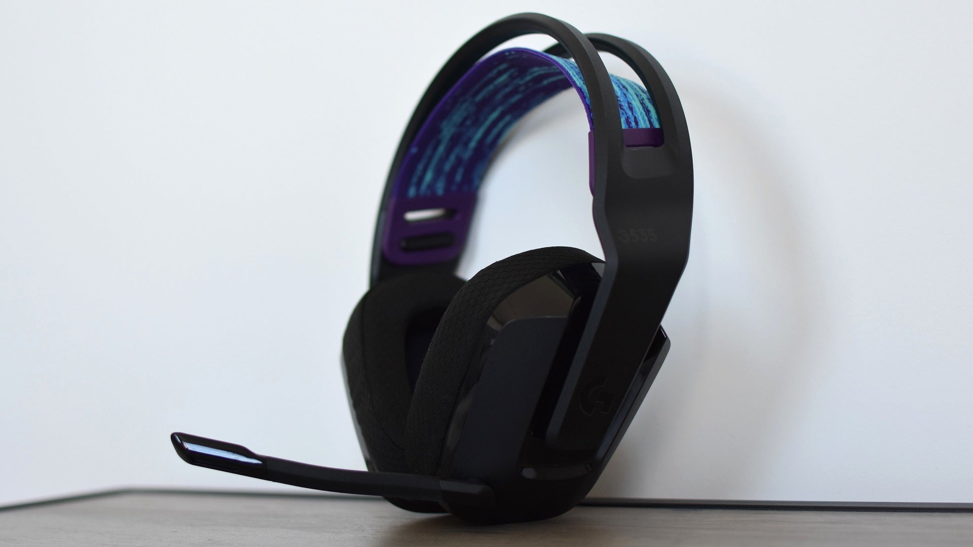 The Logitech G535 gaming headset propped up against a wall.