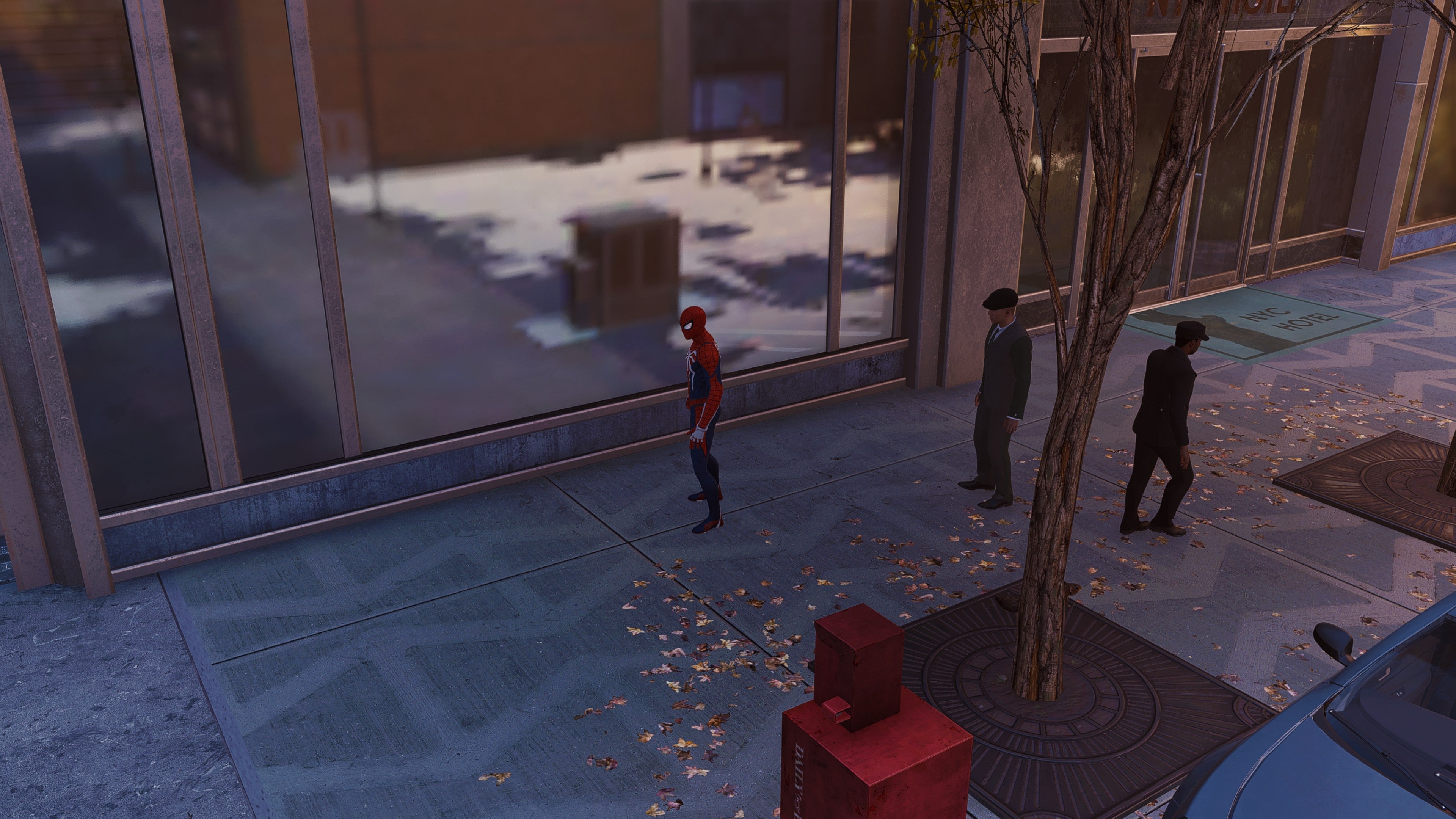 Spider-Man stands in front of a window in Marvel's Spider-Man Remastered.