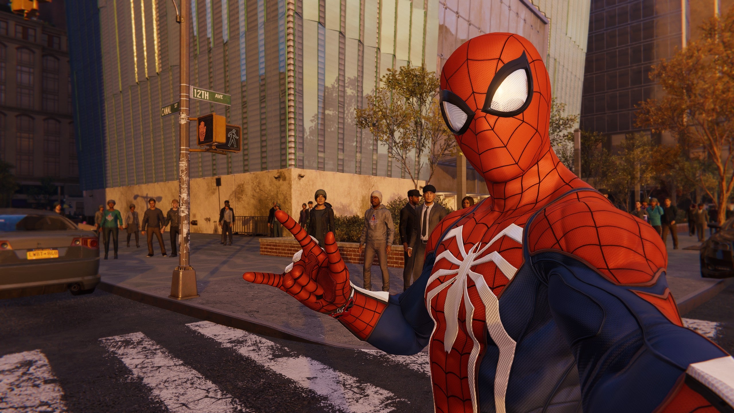 Spidey takes a selfie with some pedestrians in Marvel’s Spider-Man Remastered.