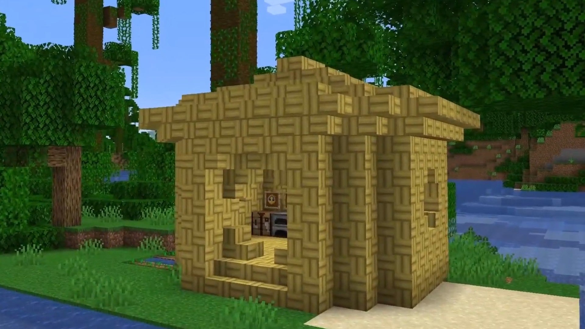 Imagen de Minecraft 1.20 que muestra una casa construida con bloques de mosaico de bambú.  Está en una jungla y junto a un río.