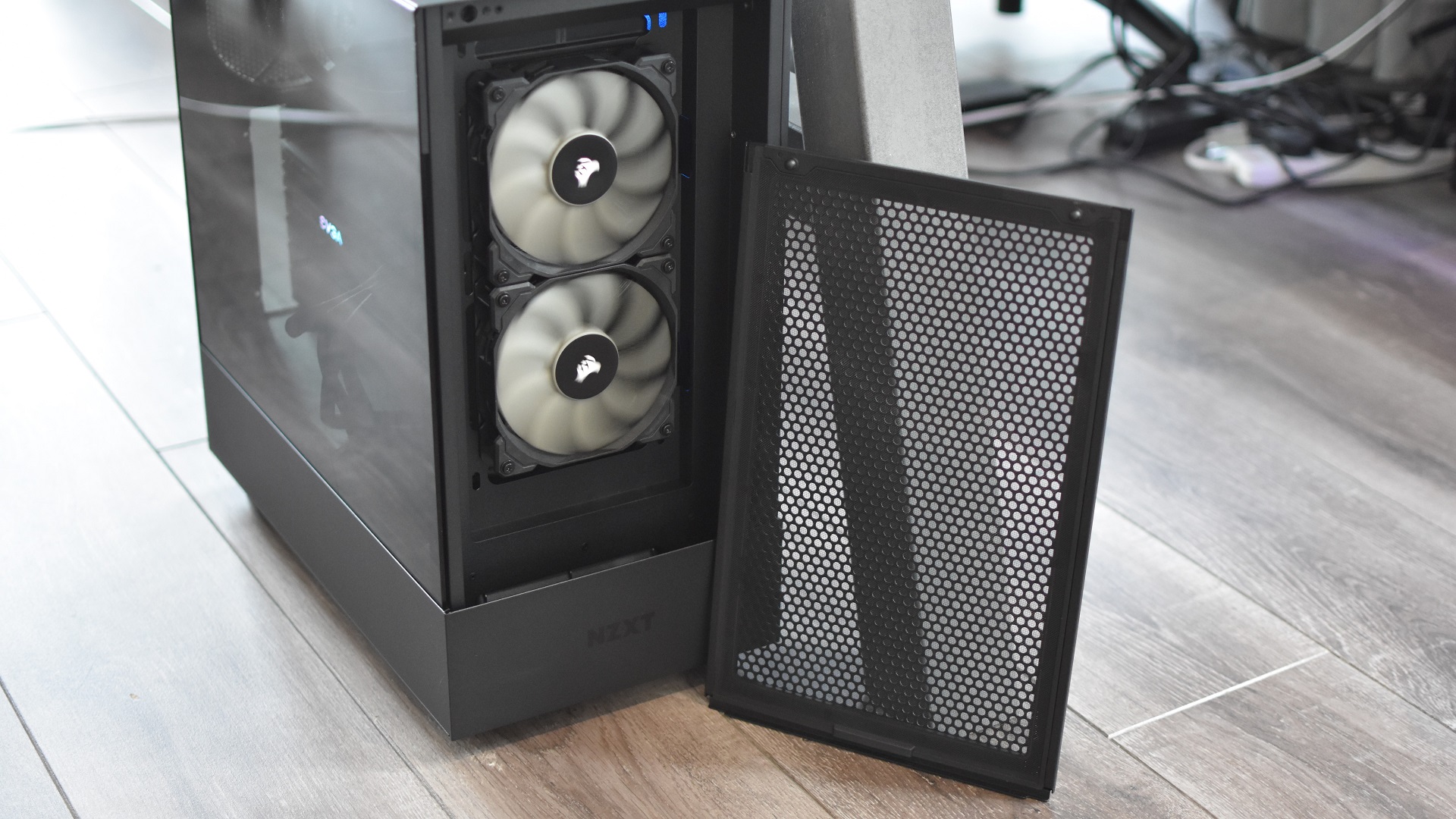 The front dust filter on the NZXT H5 Flow case, propped up against the case itself.