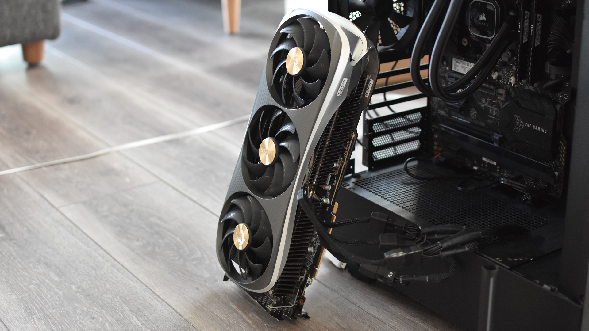 A Zotac Gaming GeForce RTX 4090 Amp Extreme Airo graphics card propped up against a PC case.