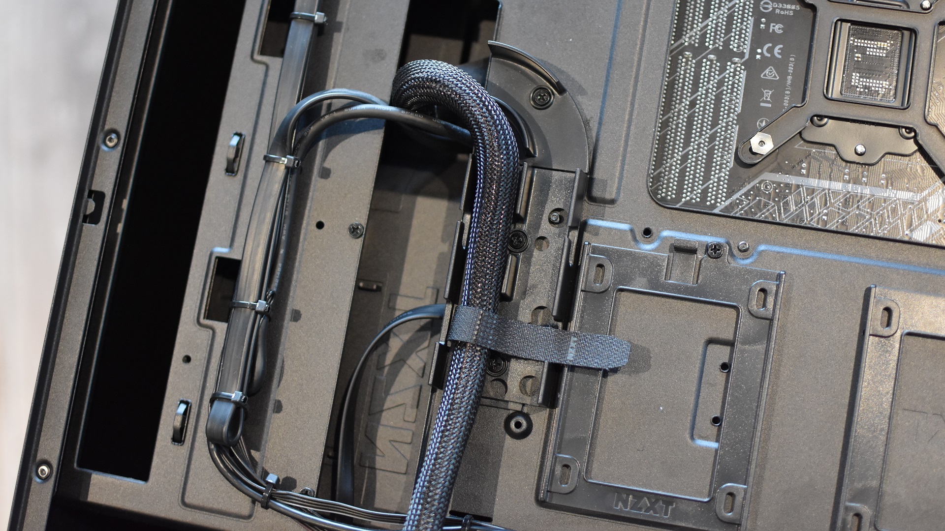 The cable routing channels inside a gaming PC case.