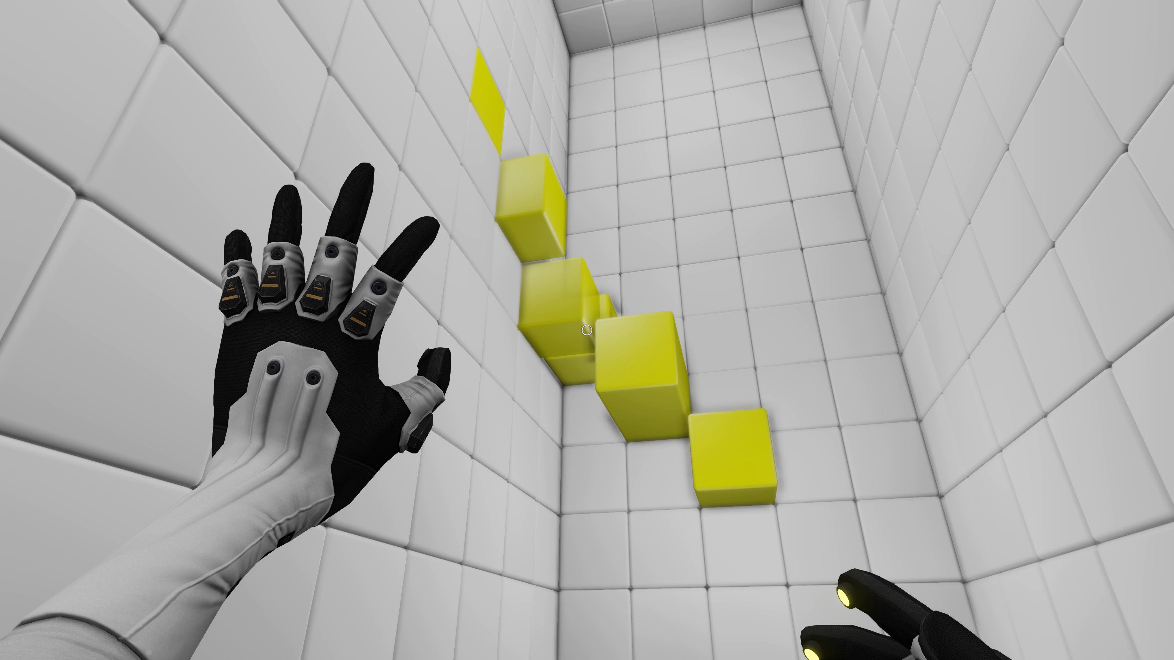 A glove reaches out toward a white wall and a bunch of yellow cubes in QUBE (2012).