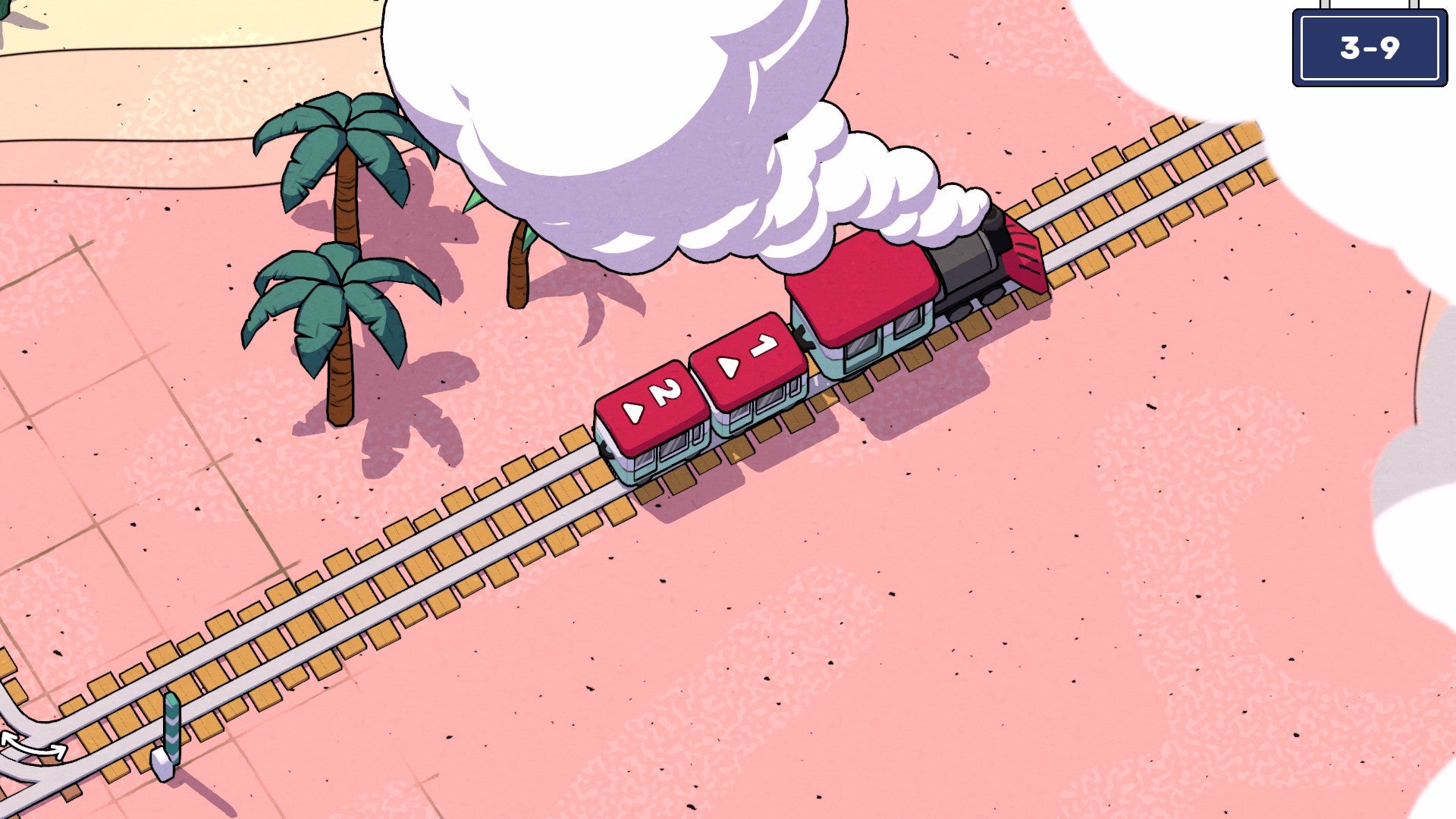 A red steam train travels down a beach track in Railbound