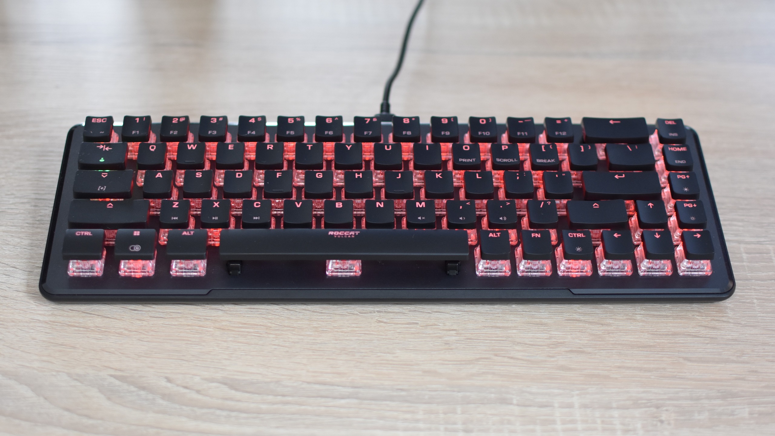 The Roccat Vulcan II Mini gaming keyboard on a desk.