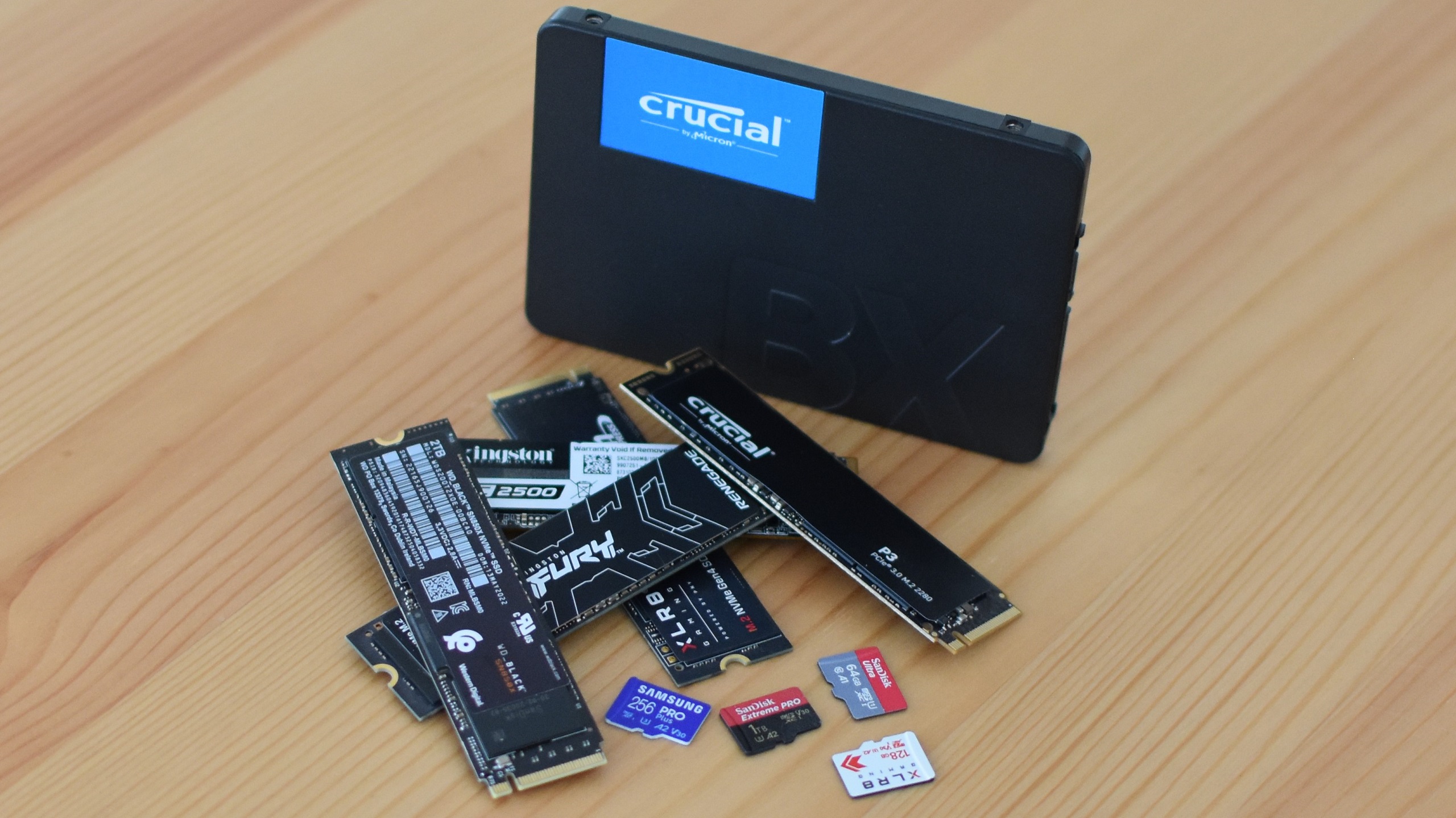 Various SSDs and microSD cards on a table.