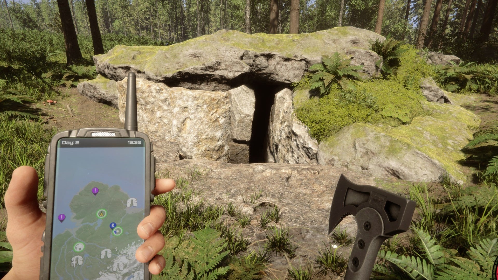 A player stares at a cave entrance while holding a GPS and an axe in Sons of the Forest.