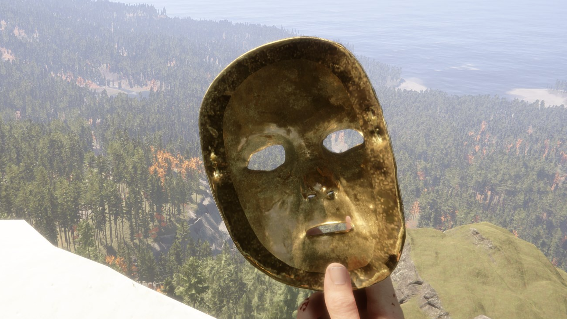 Sons of the Forest player holds the Golden Mask on a snowy mountain overlooking the forest below.