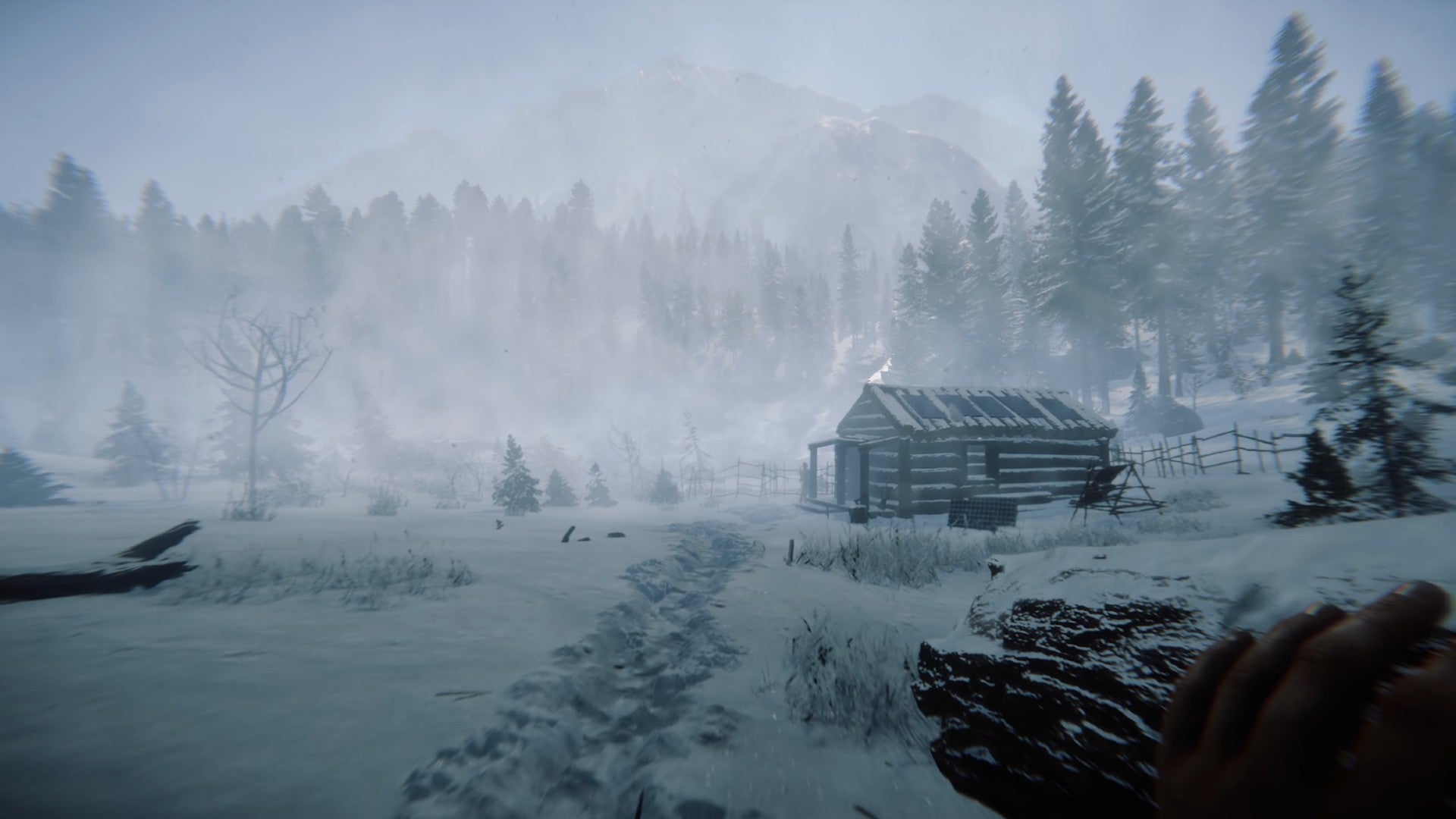 A player holding a log wanders towards their base in the snow in Sons of the Forest.