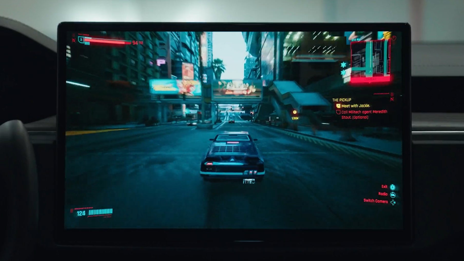 A screenshot of Cyberpunk 2077 running on Steam in a Tesla car, showing a car driving around Nighty City
