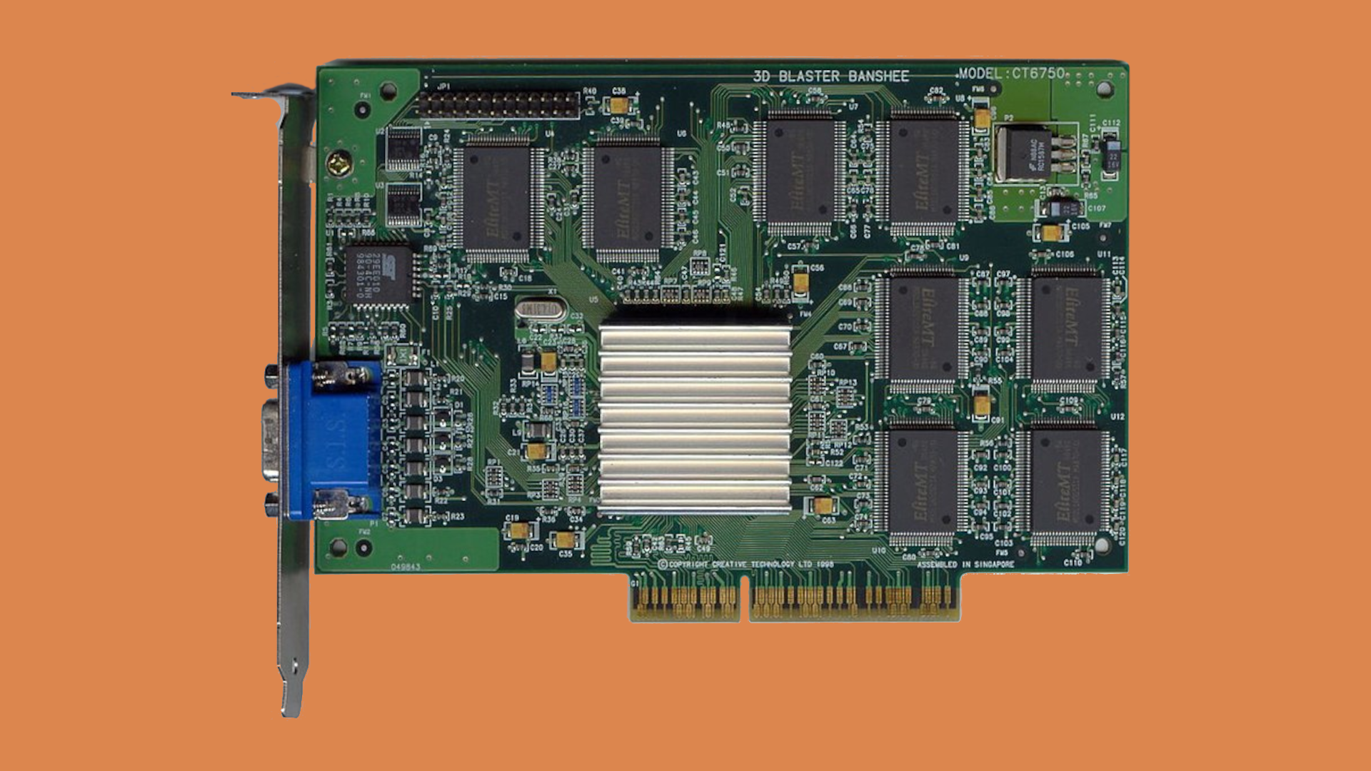 The 3dfx Voodoo Banshee AGP graphics card against an orange background.