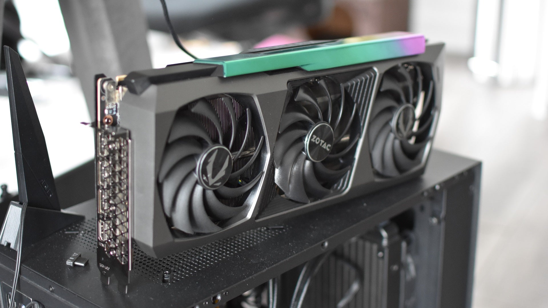 The Zotac GeForce RTX 3090 Ti AMP Extreme Holo graphics card sat on top of a PC case.