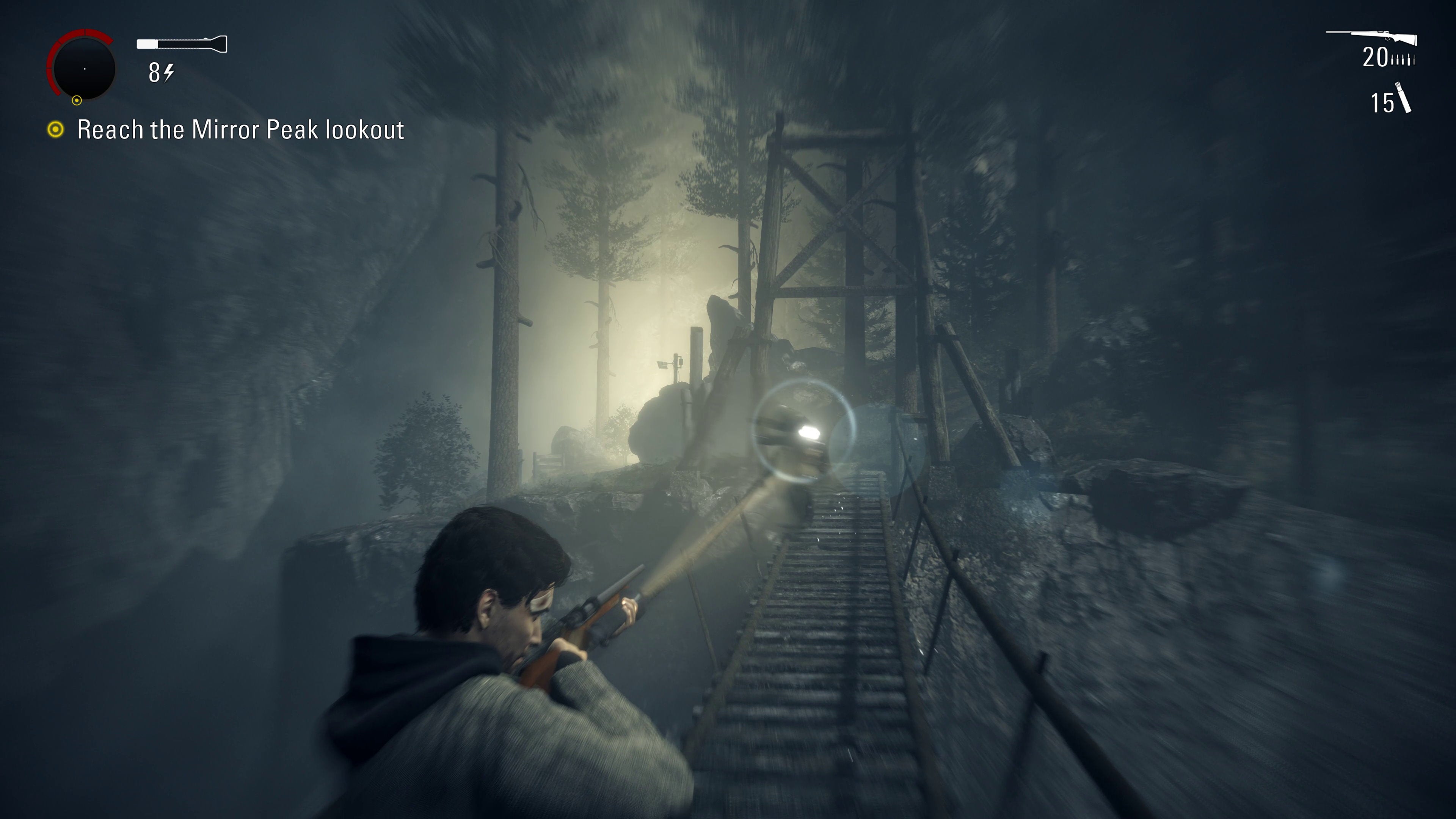 Alan aims a torch at a possessed man on a bridge from Alan Wake Remastered