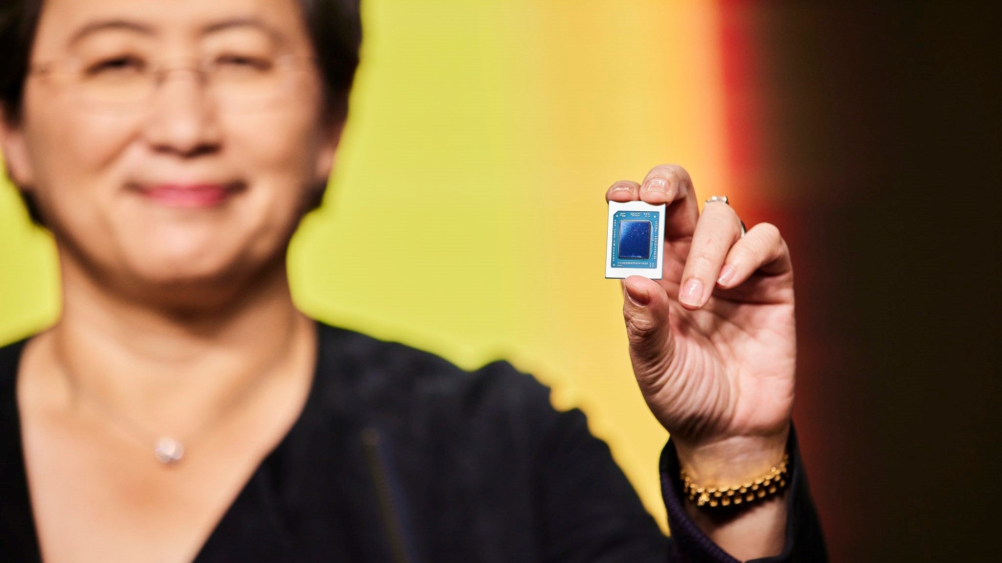AMD CEO dr Lisa Su holding an AMD Ryzen 6000 series mobile CPU.