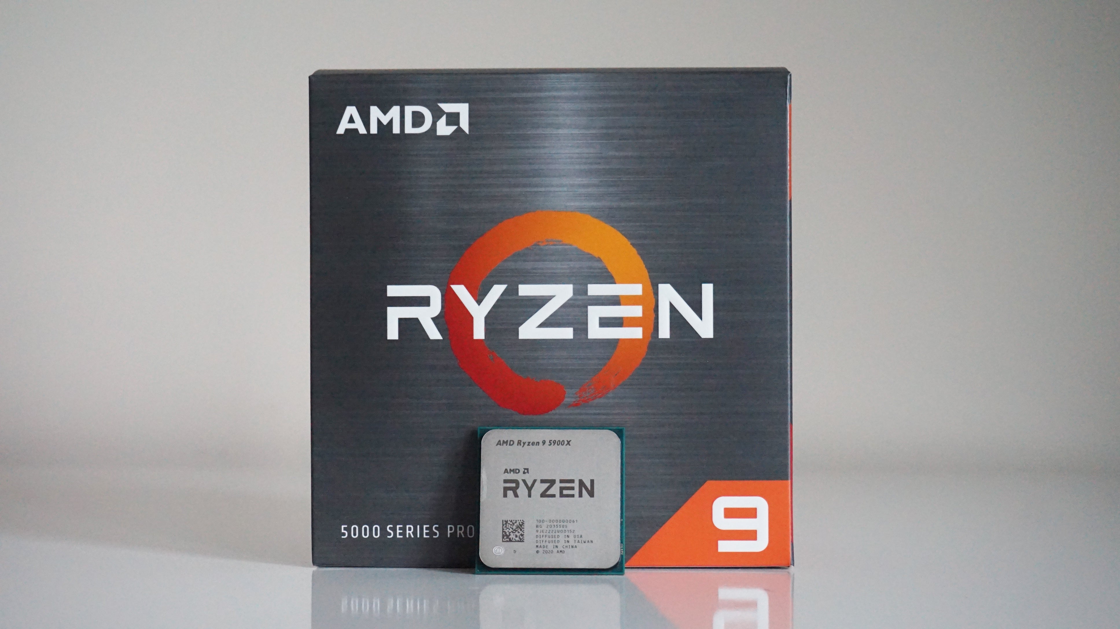 a photo of an amd ryzen 9 5900x 12-core processor in front of its box