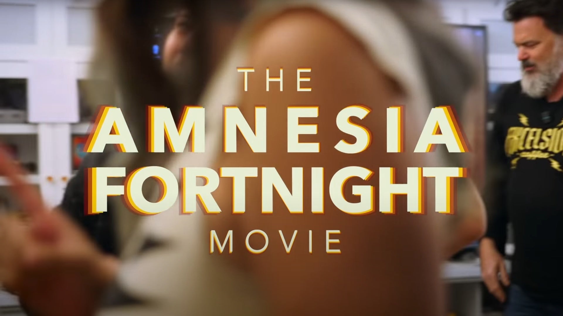 A still from the Amnesia Fortnight Movie, showing the name of the film on screen. A sneaky Tim Schafer is entering the frame from the right.