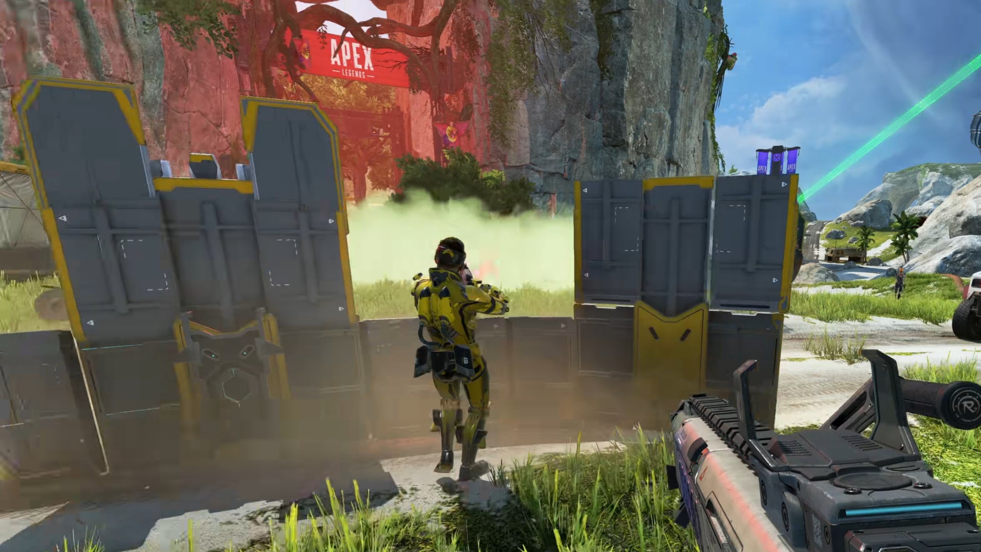 Mirage in Apex Legends fights from behind the cover of his teammate Newcastle's Shield Wall Ultimate.