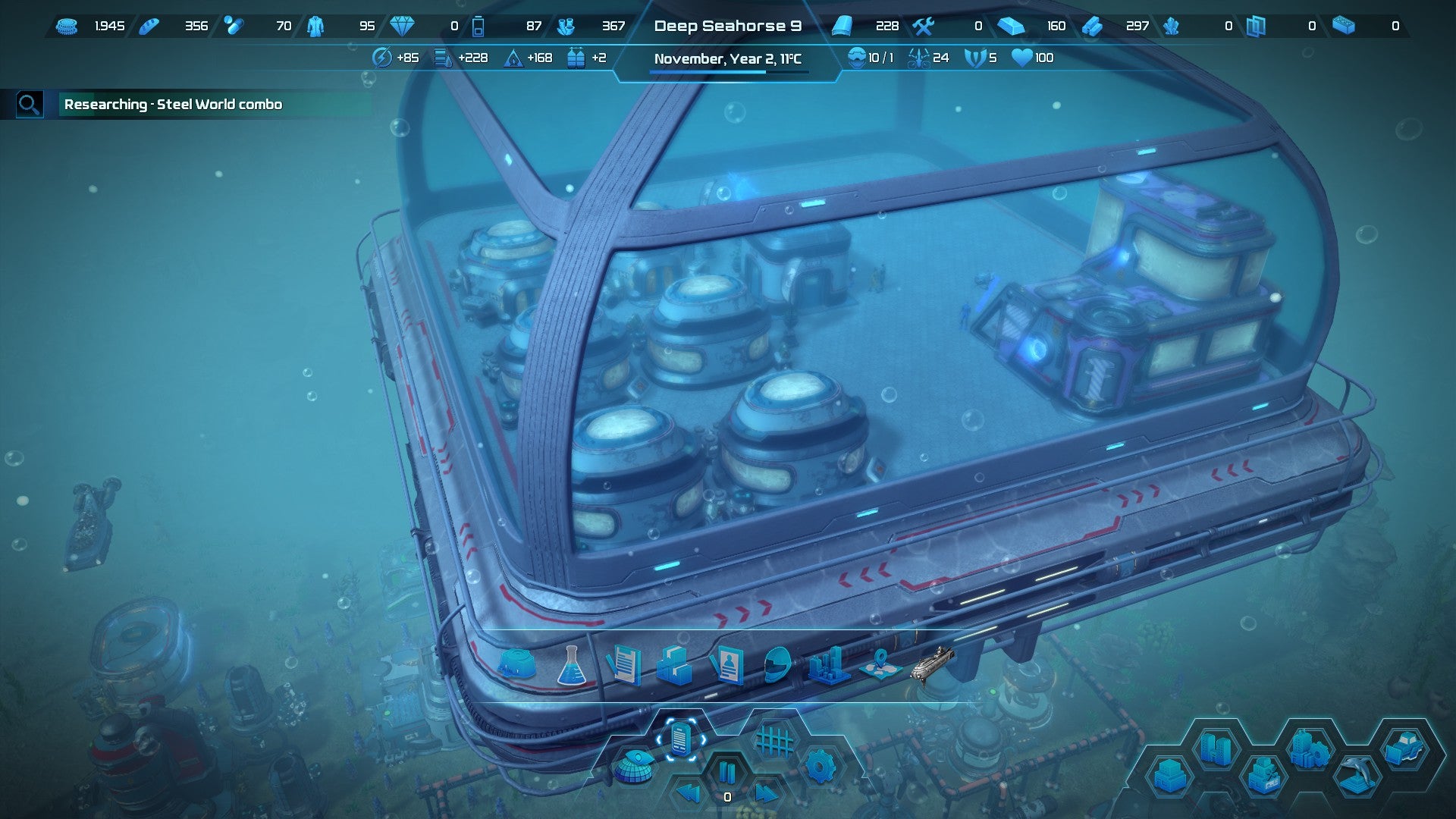 An underwater sea base with a glass ceiling and machinery inside.
