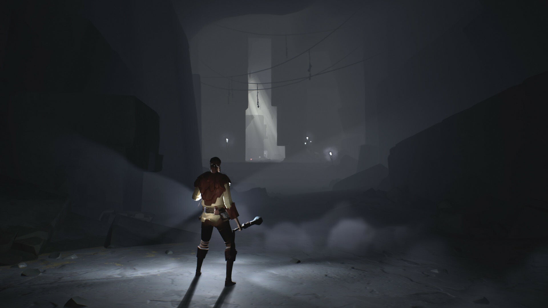 Someone holds a lamp to light their way in Ashen.