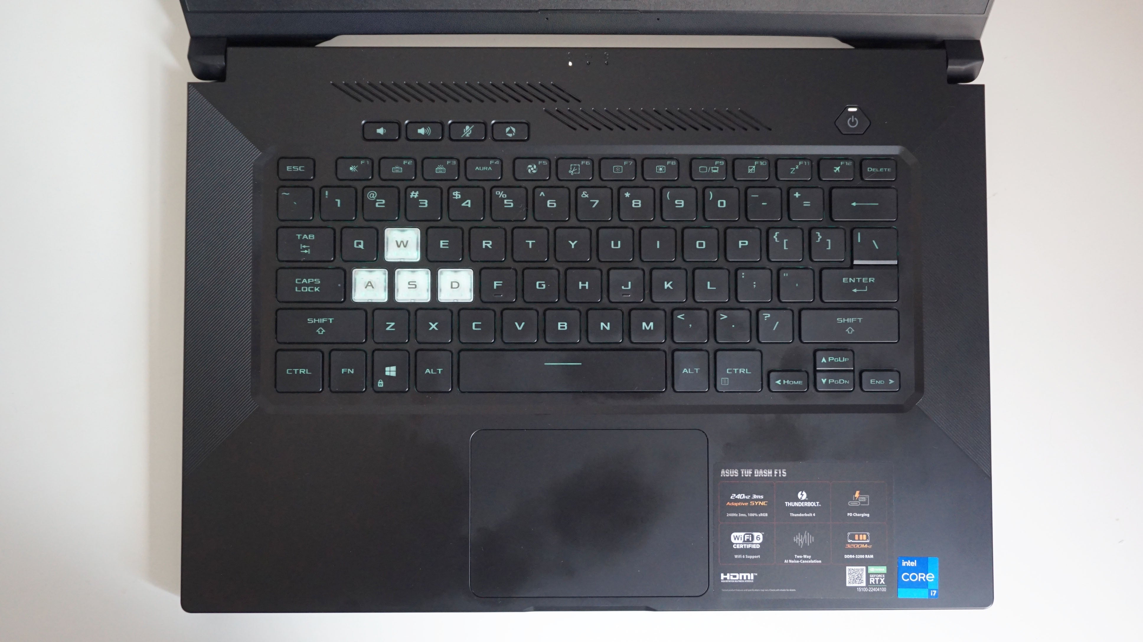 A photo of the Asus TUF Dash 15 gaming laptop's keyboard on a white desk