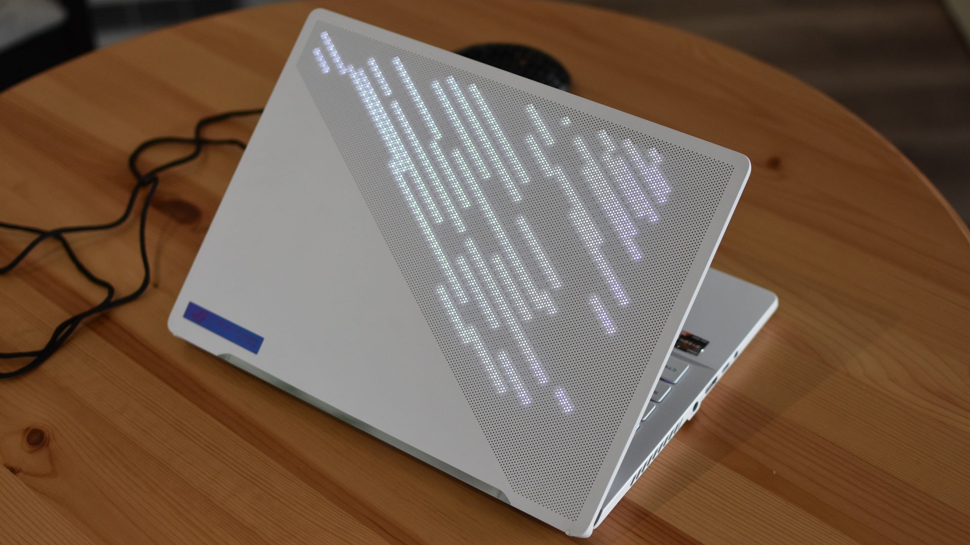 The AinMe Matrix display illuminating the Asus ROG Zephyrus G14 gaming laptop.