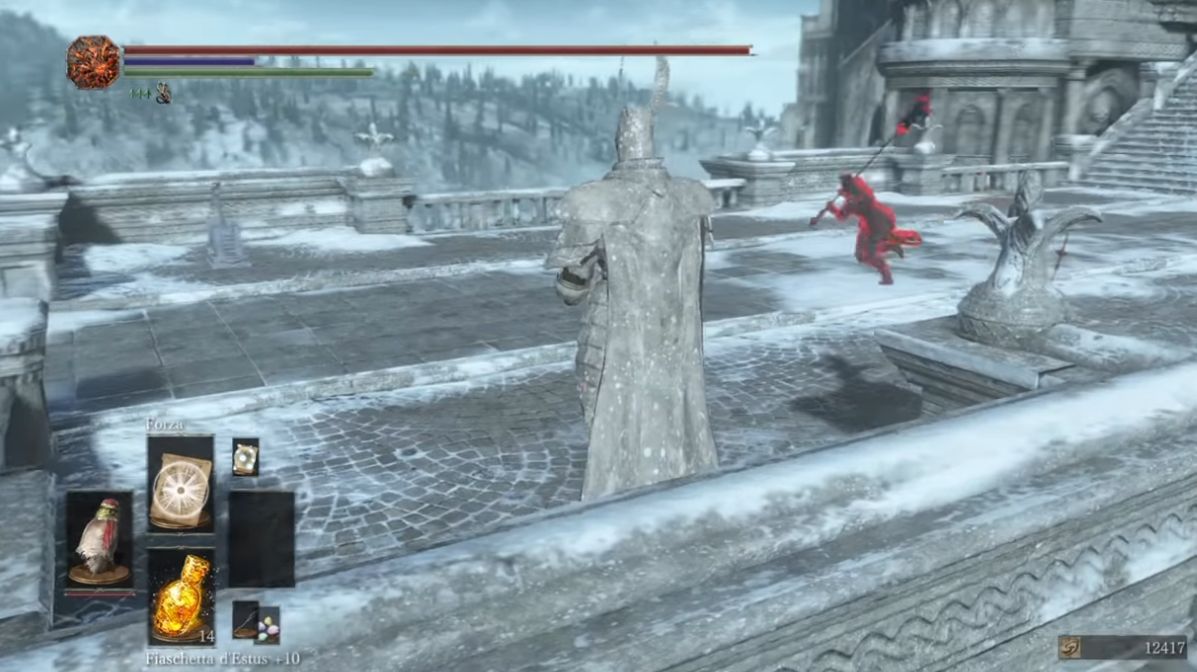The player character in Dark Souls leaps towards the back of a giant statue, on a snowy courtyard