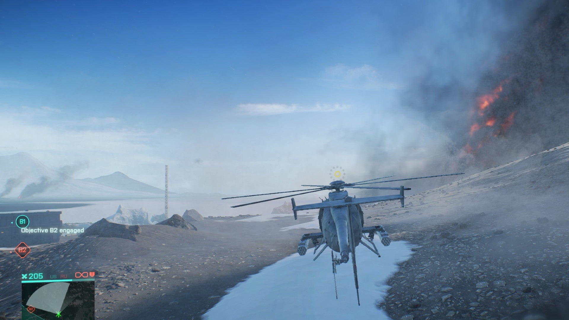 A Nightbird helicopter on land in Battlefield 2042. Fire and smoke are in the background, while the chopper sits on a snowy path in the mountains.