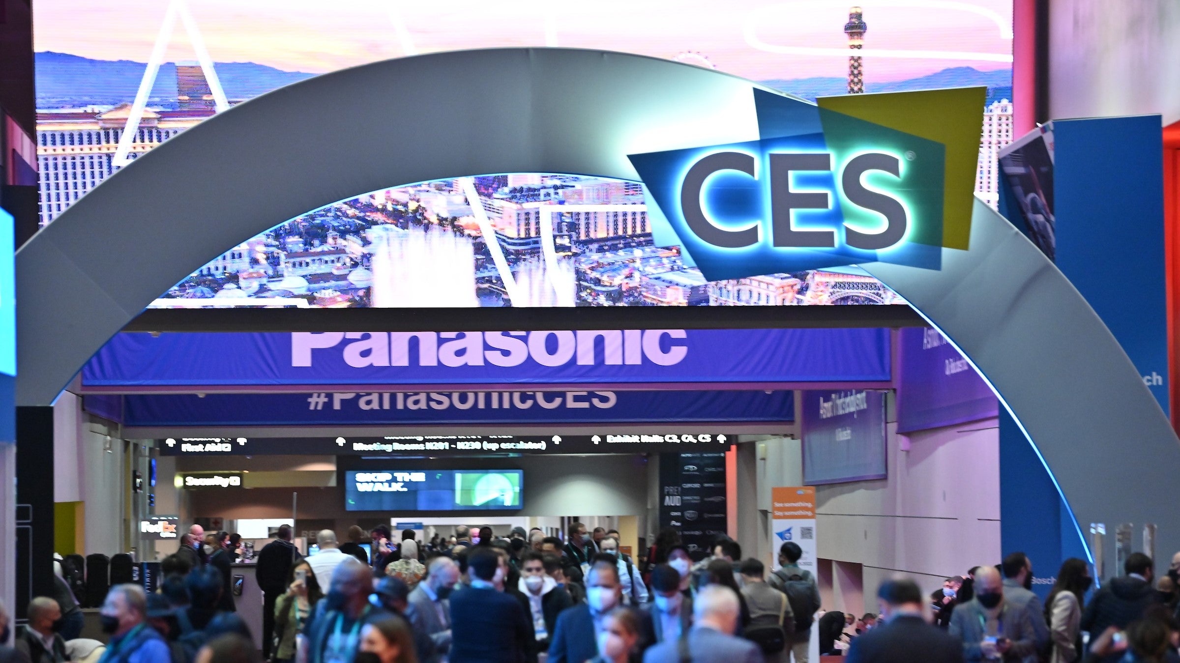 A busy scene from the CES 2022 show floor, with CES signage shown on an large arch.