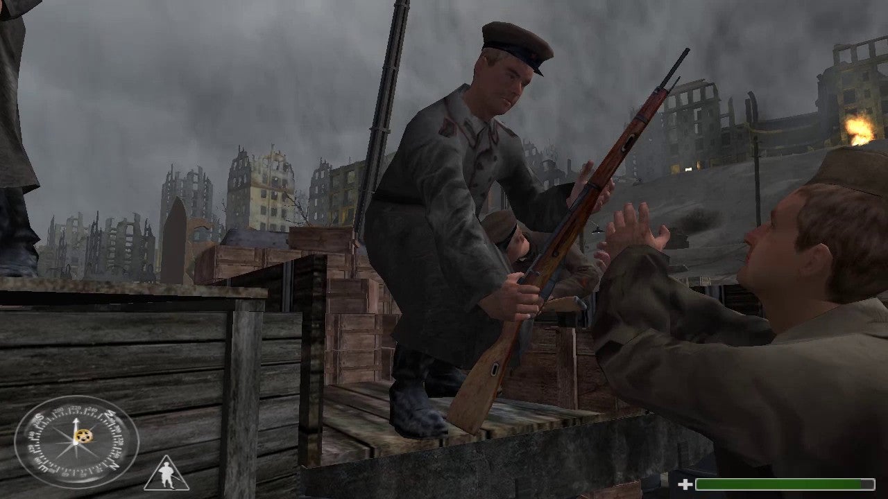 A soldier hands a gun to a man in a bombed out city in Call Of Duty