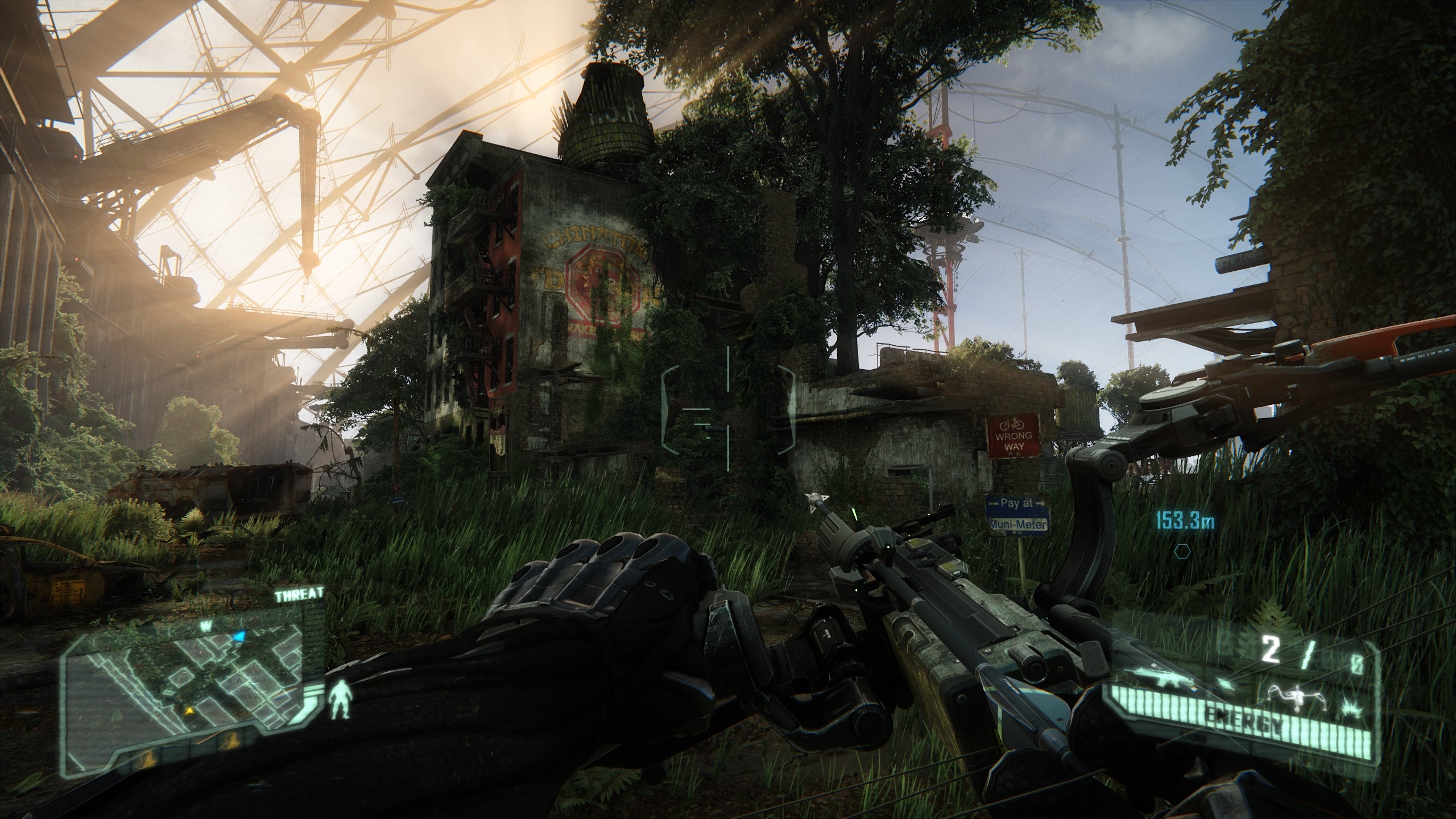 An old brick building covered by trees and surrounded by overgrown grass in Crysis 3.