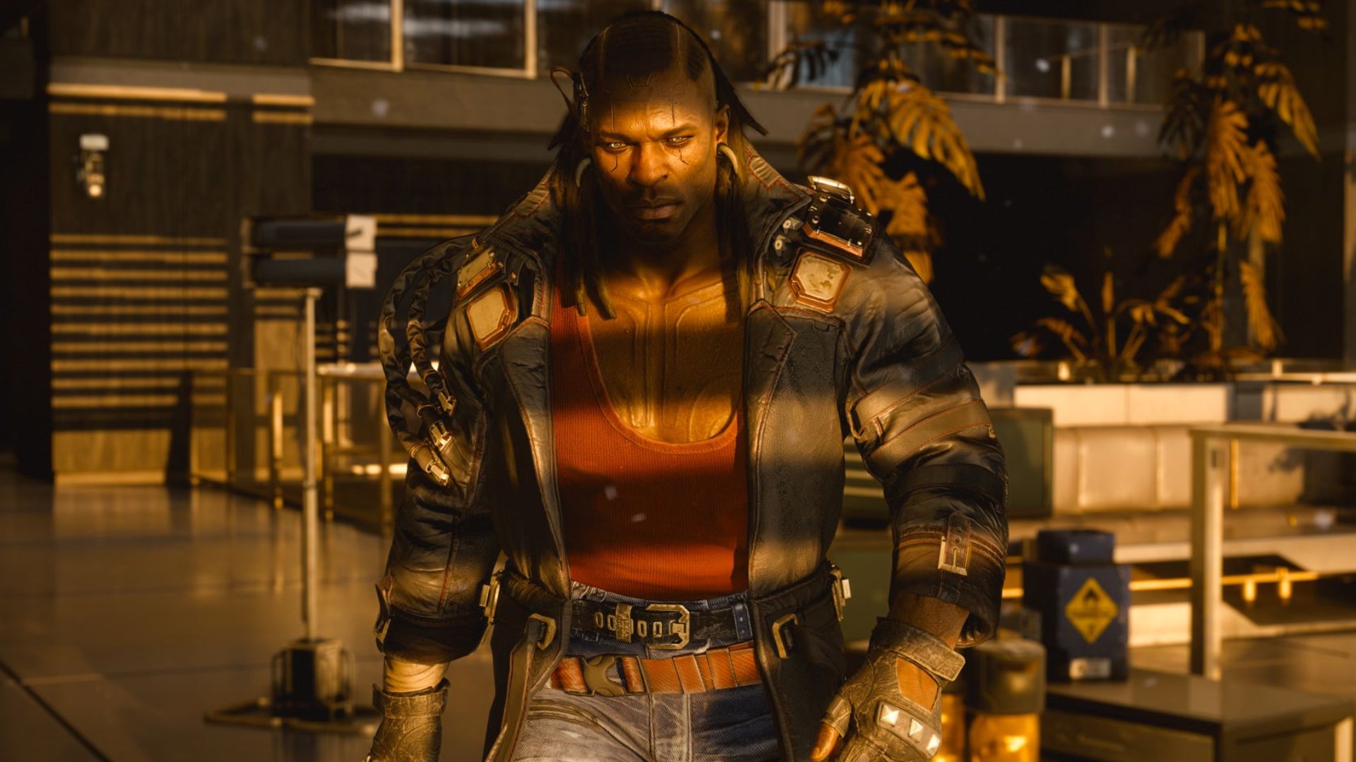 A character in an indoor location in Cyberpunk 2077 walks towards the camera.