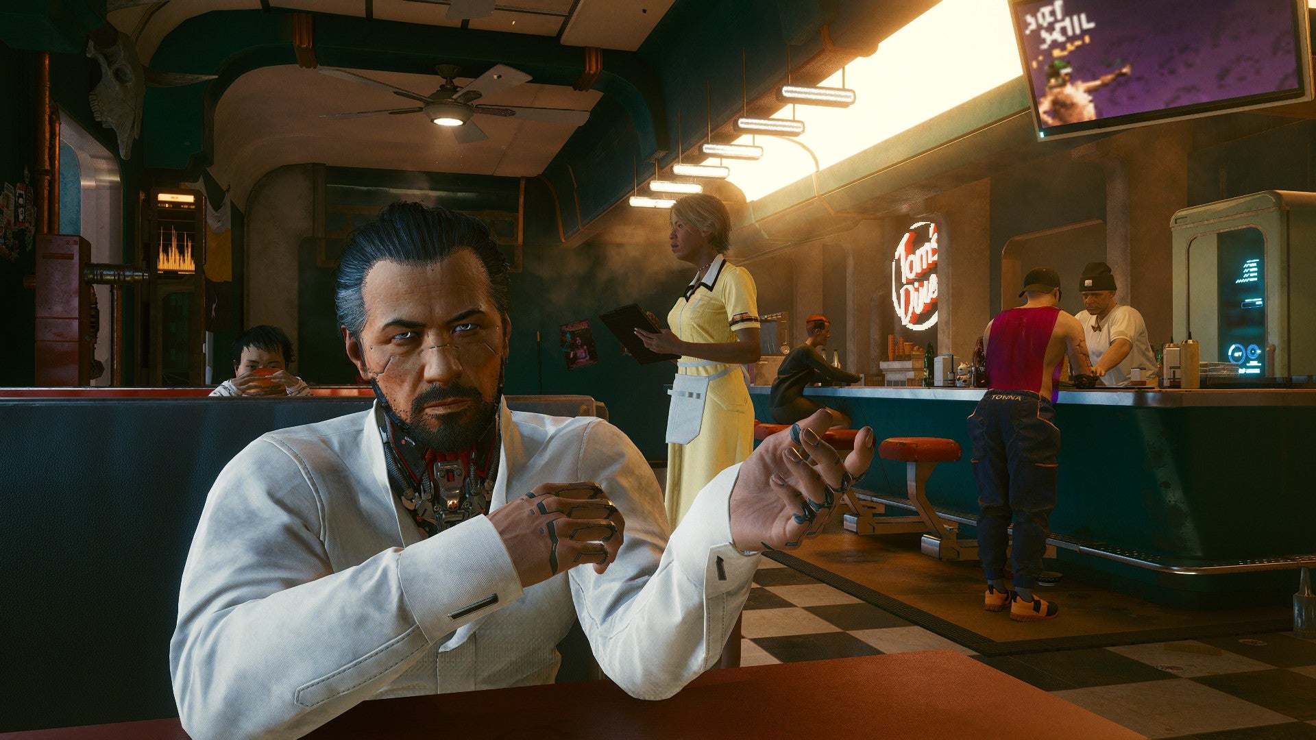 A Cyberpunk 2077 screenshot of Takemura sitting in a bar next to the player, wearing a white suit.