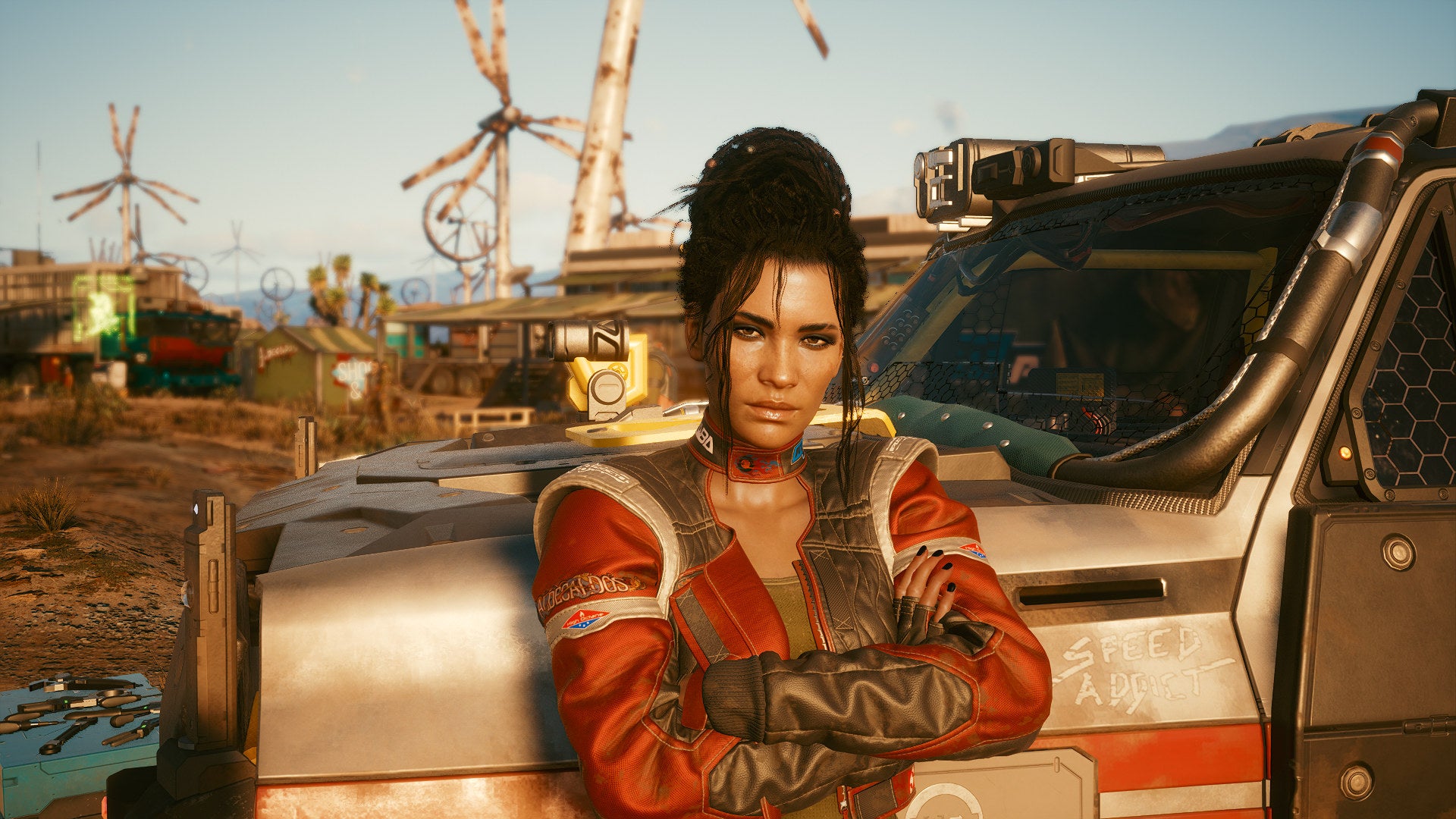 Panam leans against her car in a Cyberpunk 2077 screenshot.