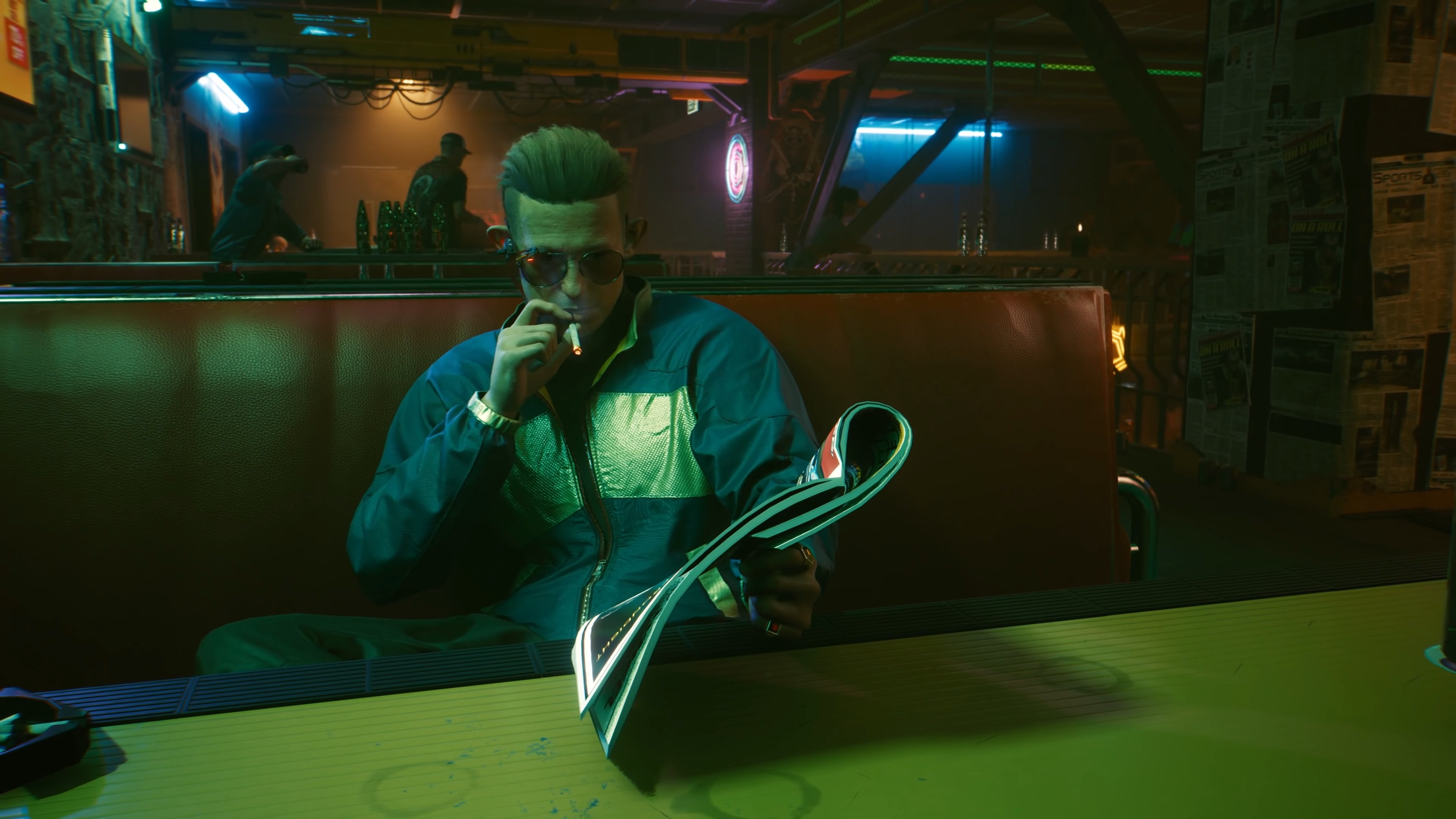 The player in Cyberpunk 2077 sits in a bar and speaks to Kirk, a character from the Street Kid prologue mission.