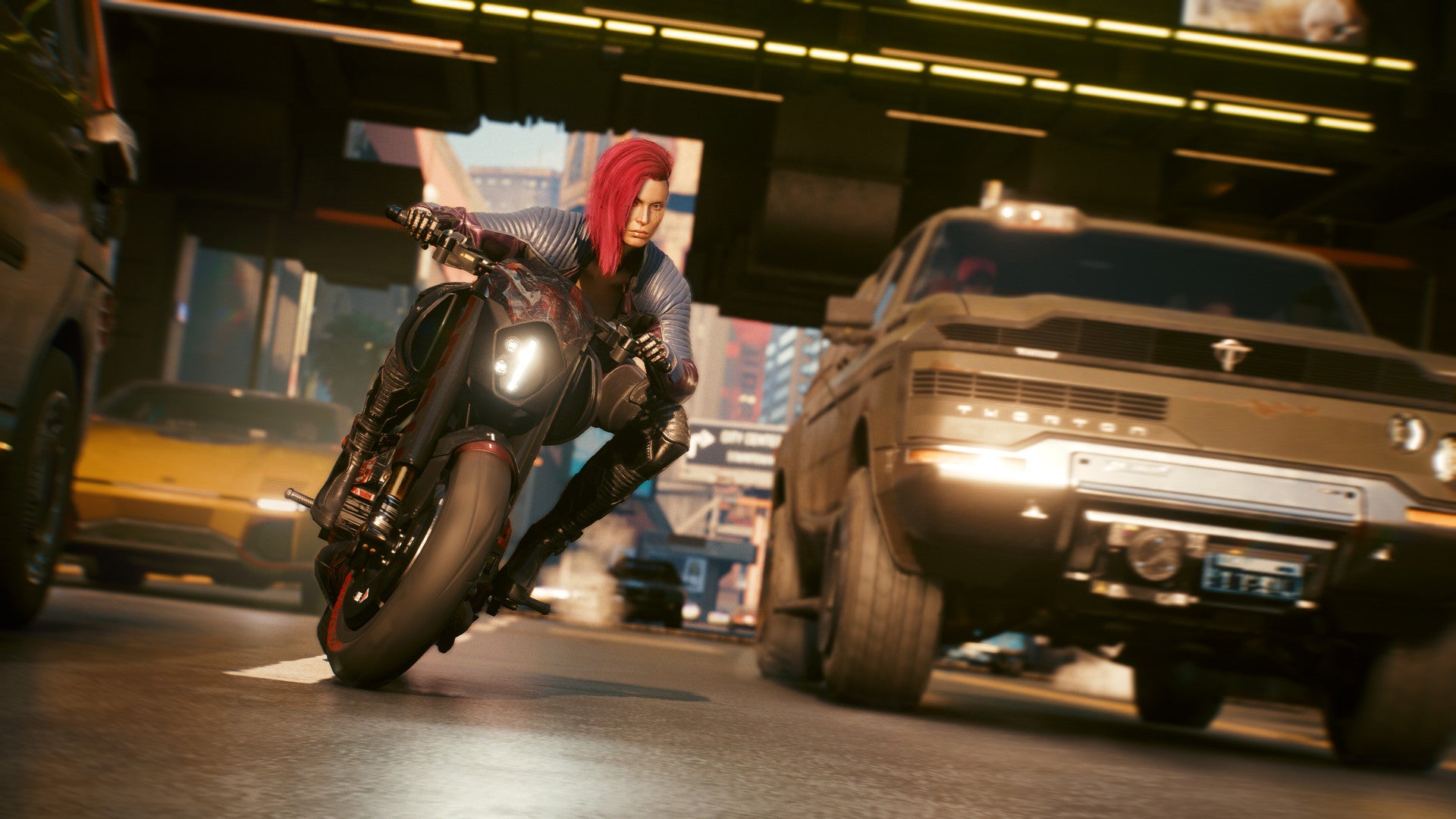 Female V riding a motorcycle through the streets of Night City in Cyberpunk 2077.